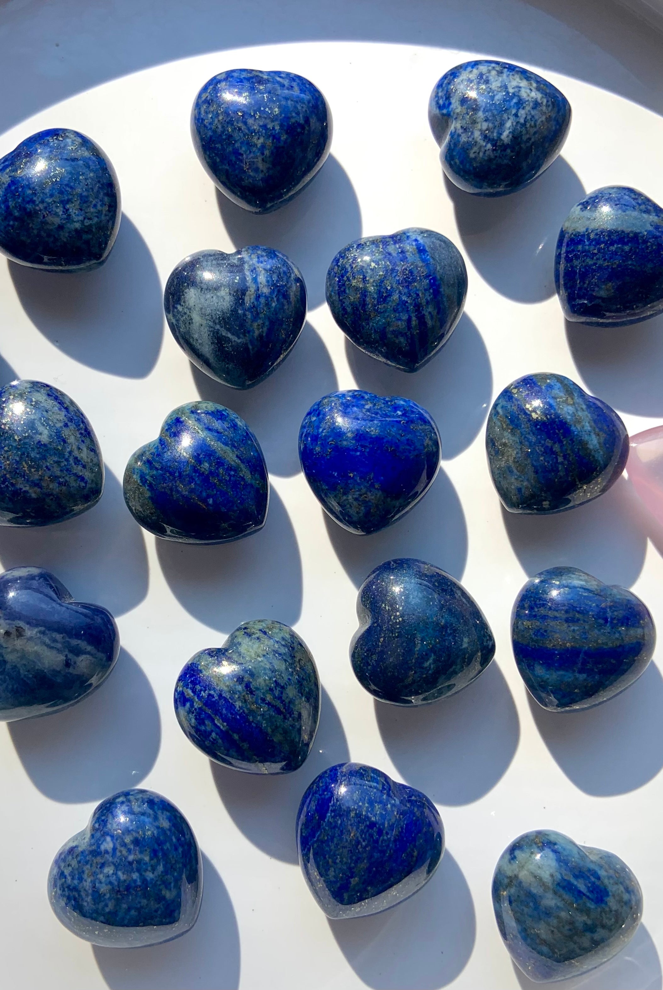A close up view our mini sized, blue Lapis Lazuli Hearts with sparkling pyrite inclusions