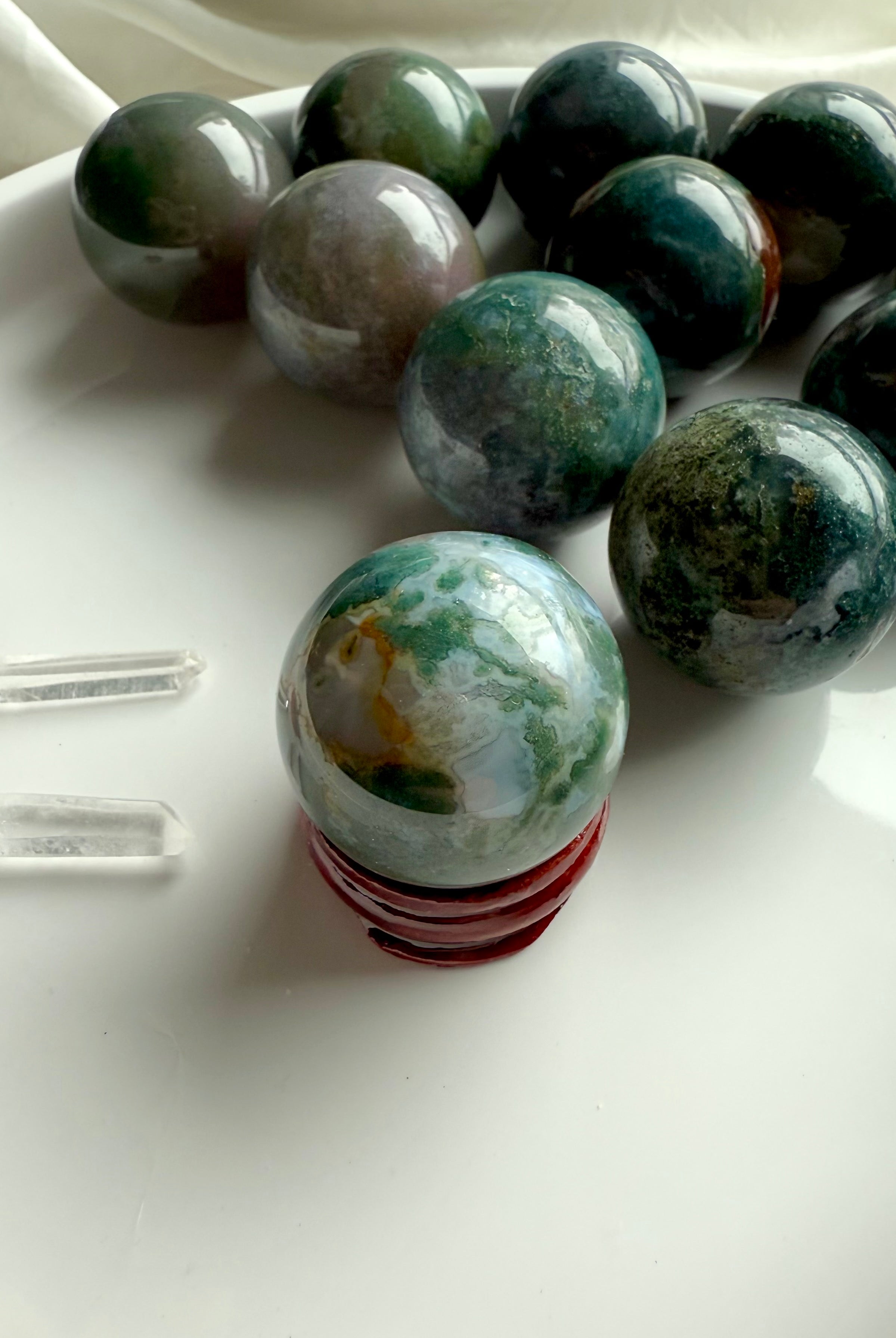 Colorful moss agate mini spheres shown on the simple wood stand option available in the dropdown
