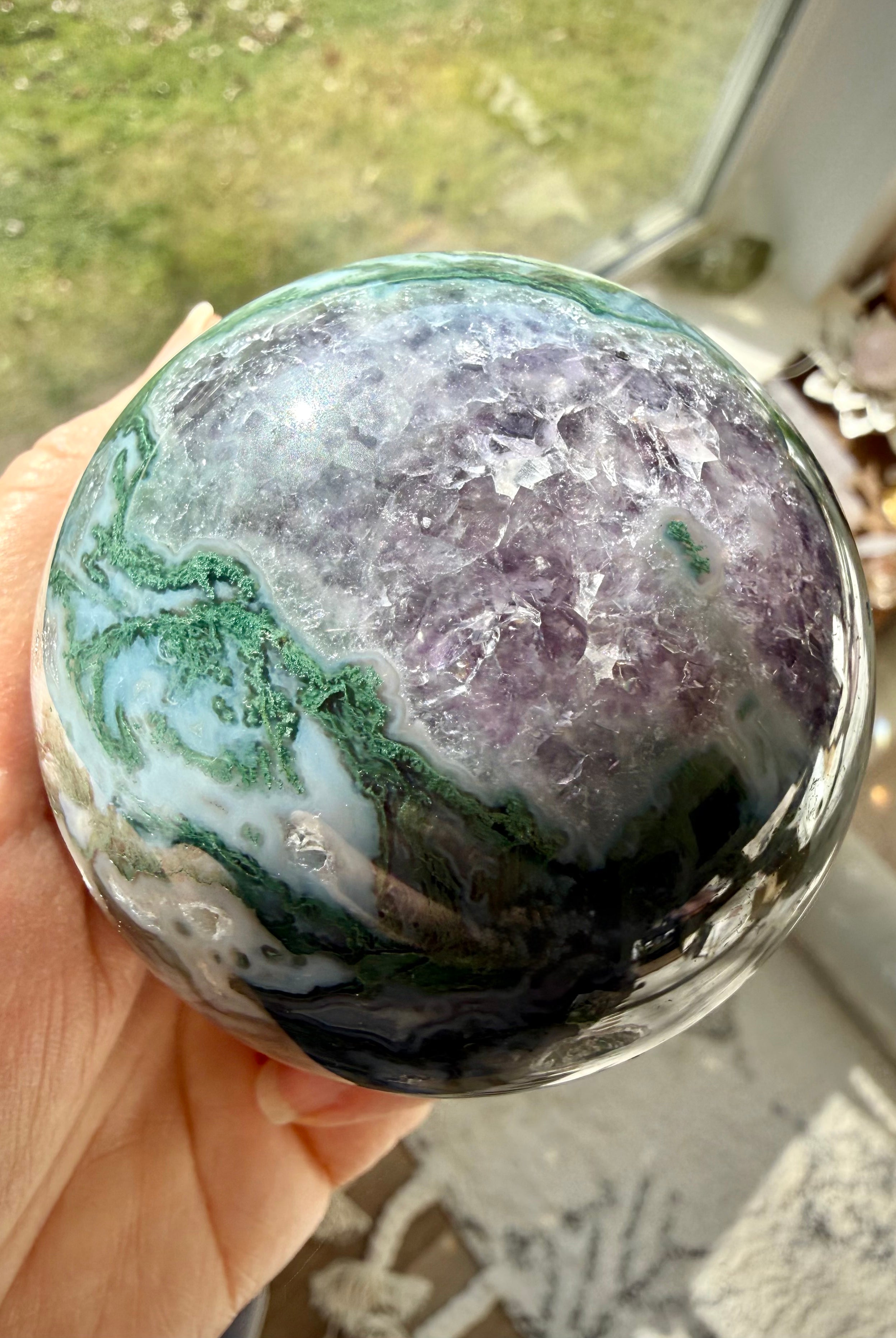 Moss Agate Amethyst sphere close up showing natural crystal patterns, druzy texture, and polished finish