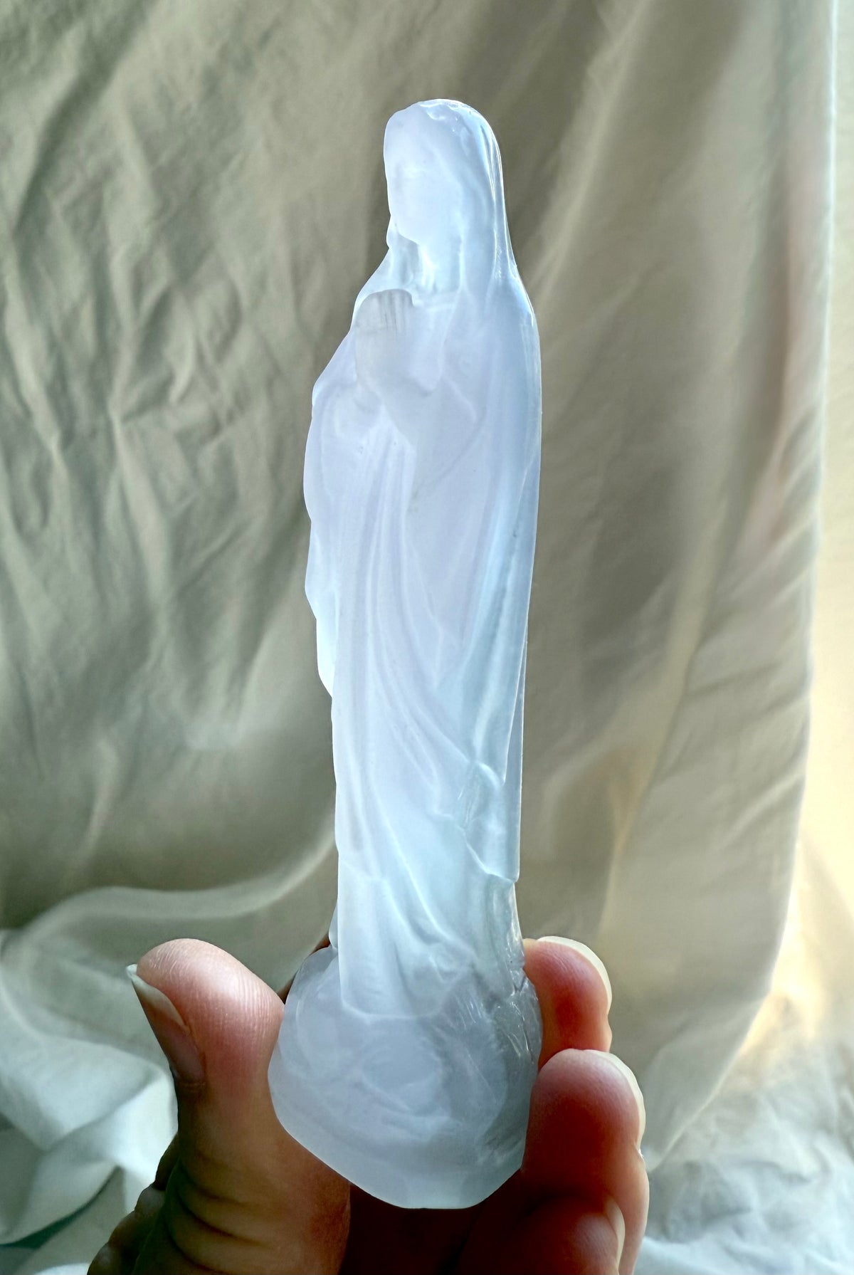 Lavender Fluorite Mother Mary figurine showing the serene prayer pose and softly translucent pastel crystal