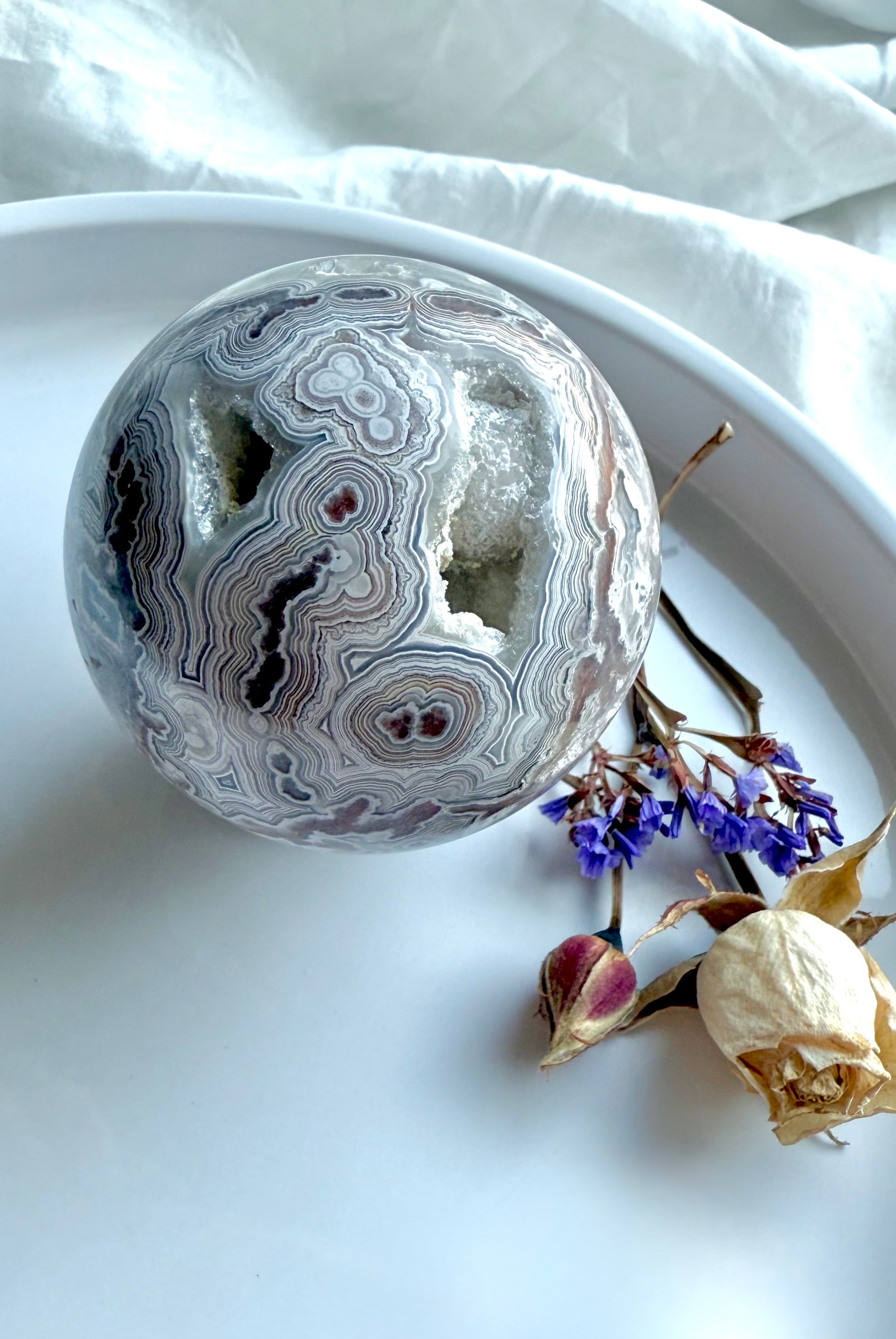 Crazy Lace Agate crystal sphere with pink quartz druzy, striking lace formations, and layered swirls of red and white