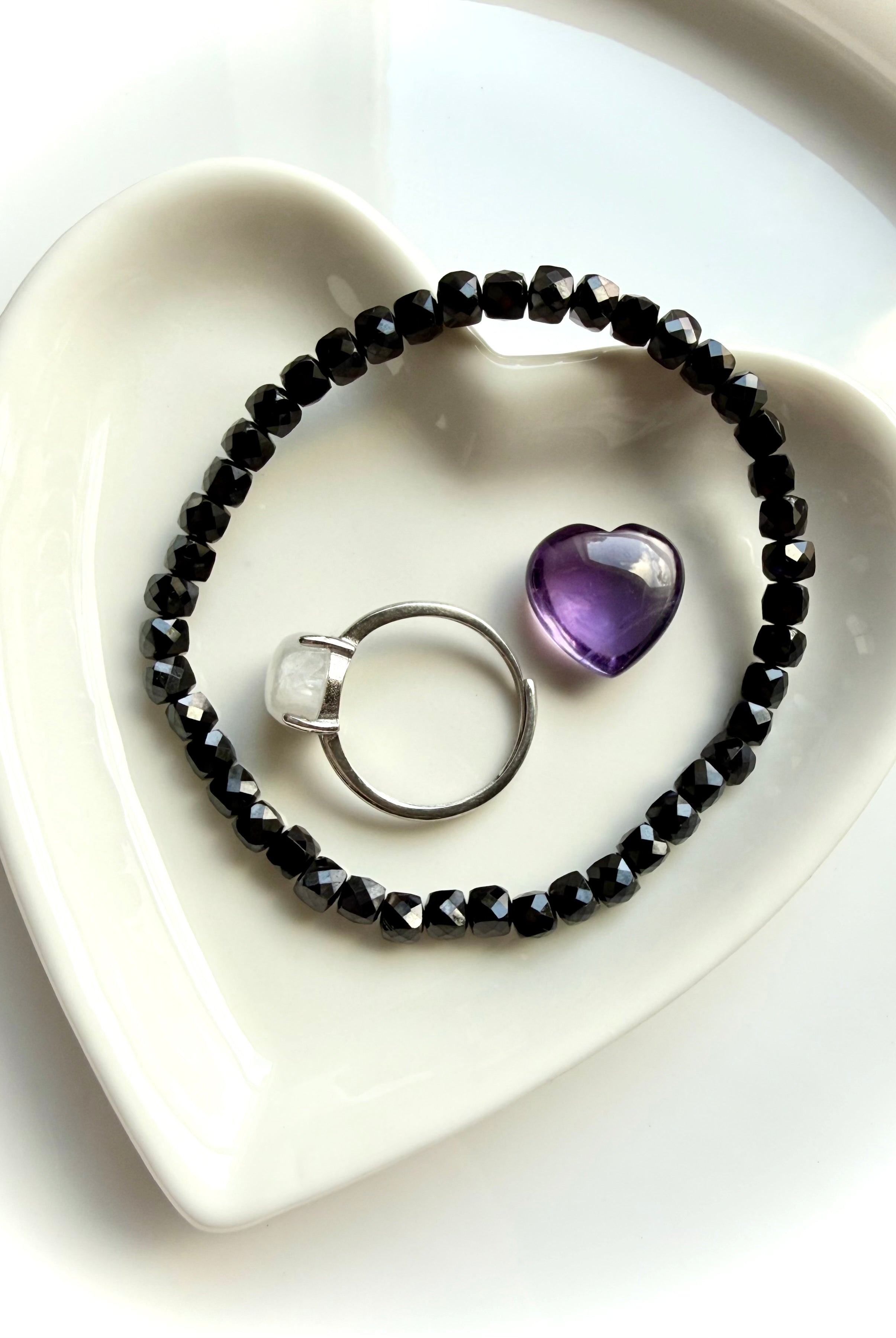 black spinel bracelet with crystal accents on dish for protection and energy clearing