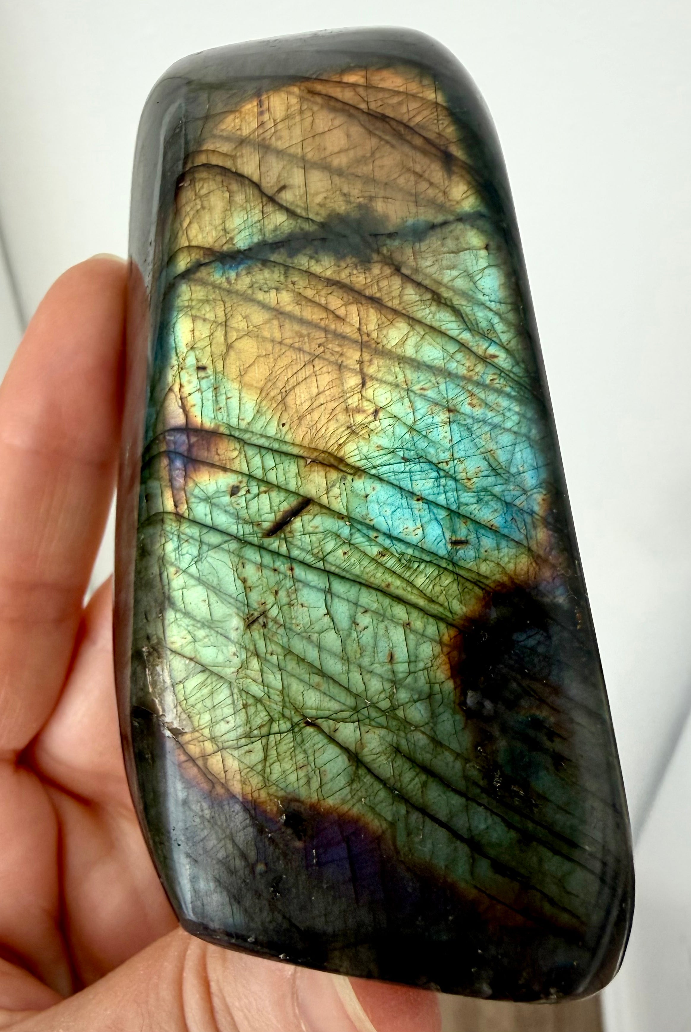 Labradorite freeform reverse view showing subtle green, gold, aqua, and copper labradorescence and natural patterning