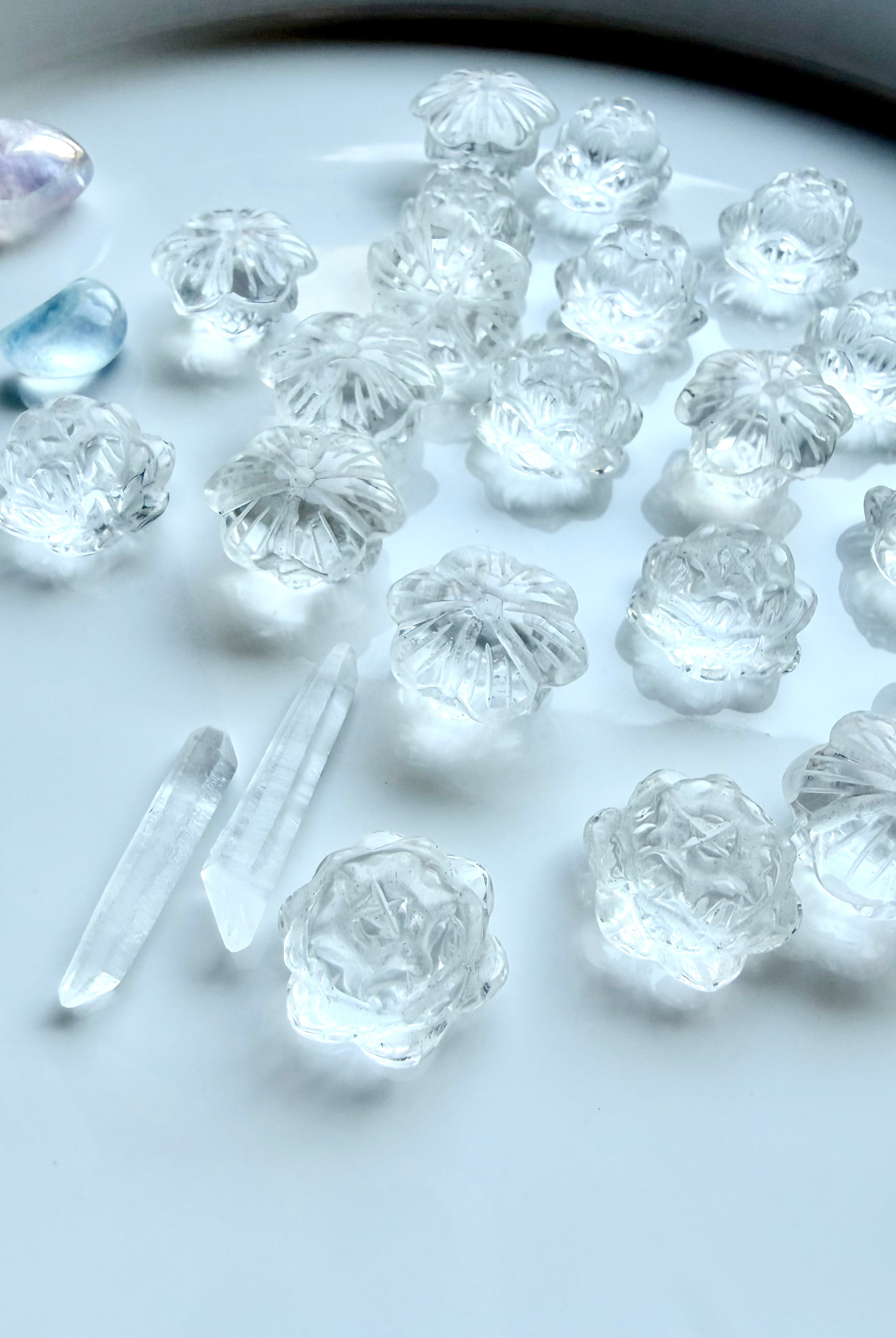 Mini Clear Quartz lotus flower carvings arranged together, small healing crystals for meditation and intention setting