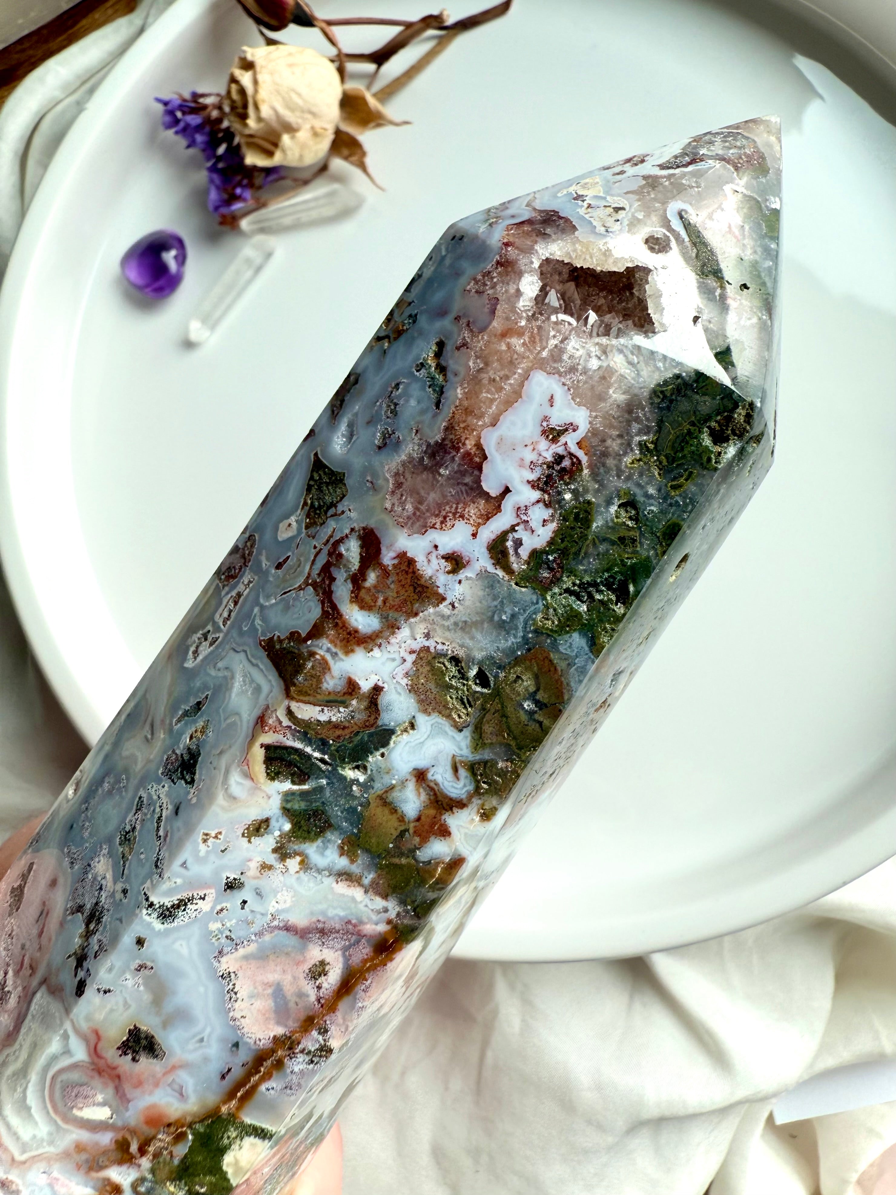 Close-up of Cosmic Ocean Jasper tower showing druzy quartz cavities and layered chalcedony banding in soft ocean tones