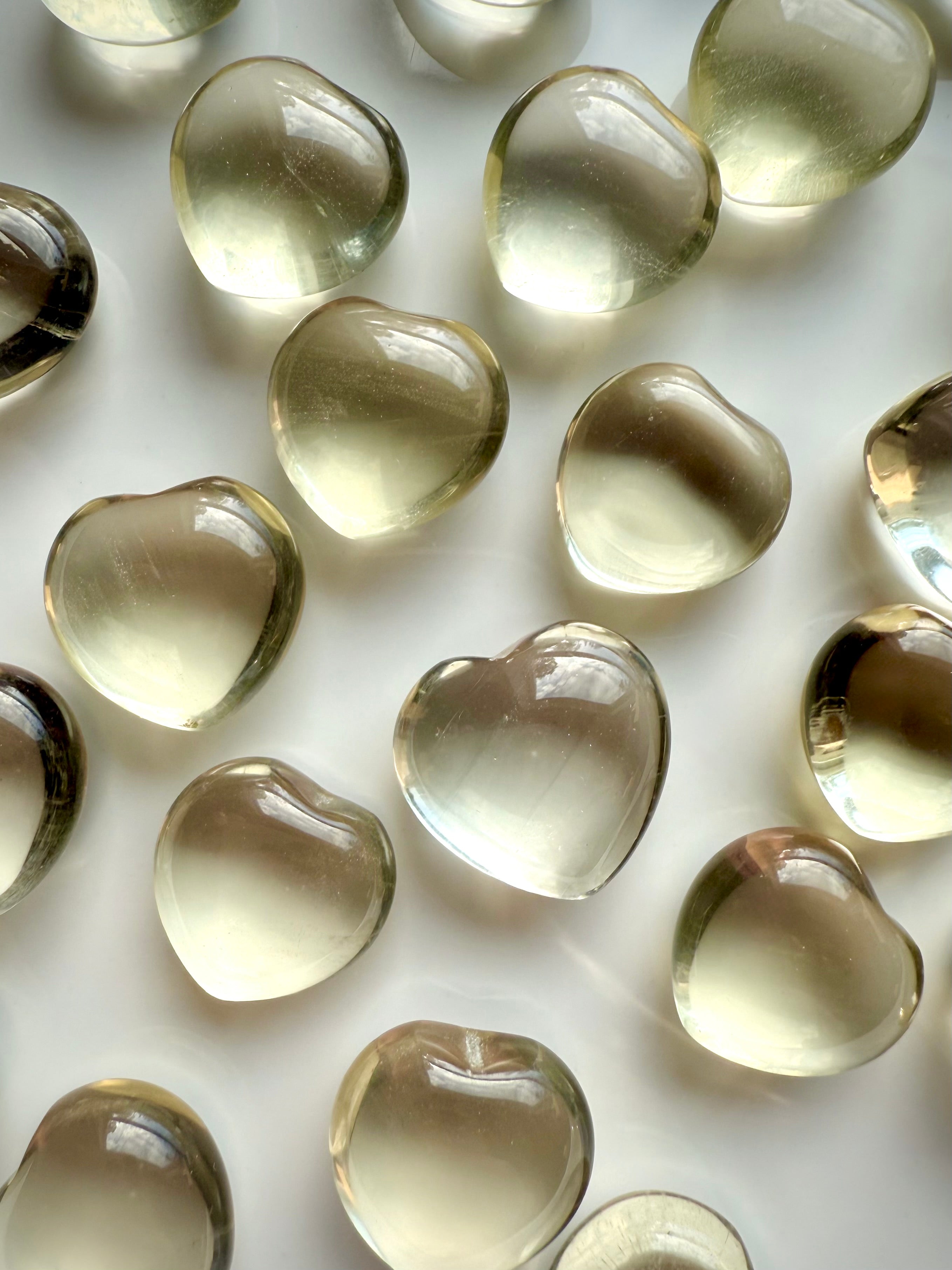 Mini Lemon Citrine heart crystal close-up on white background, polished yellow citrine for joy, confidence, and Solar Plexus Chakra healing