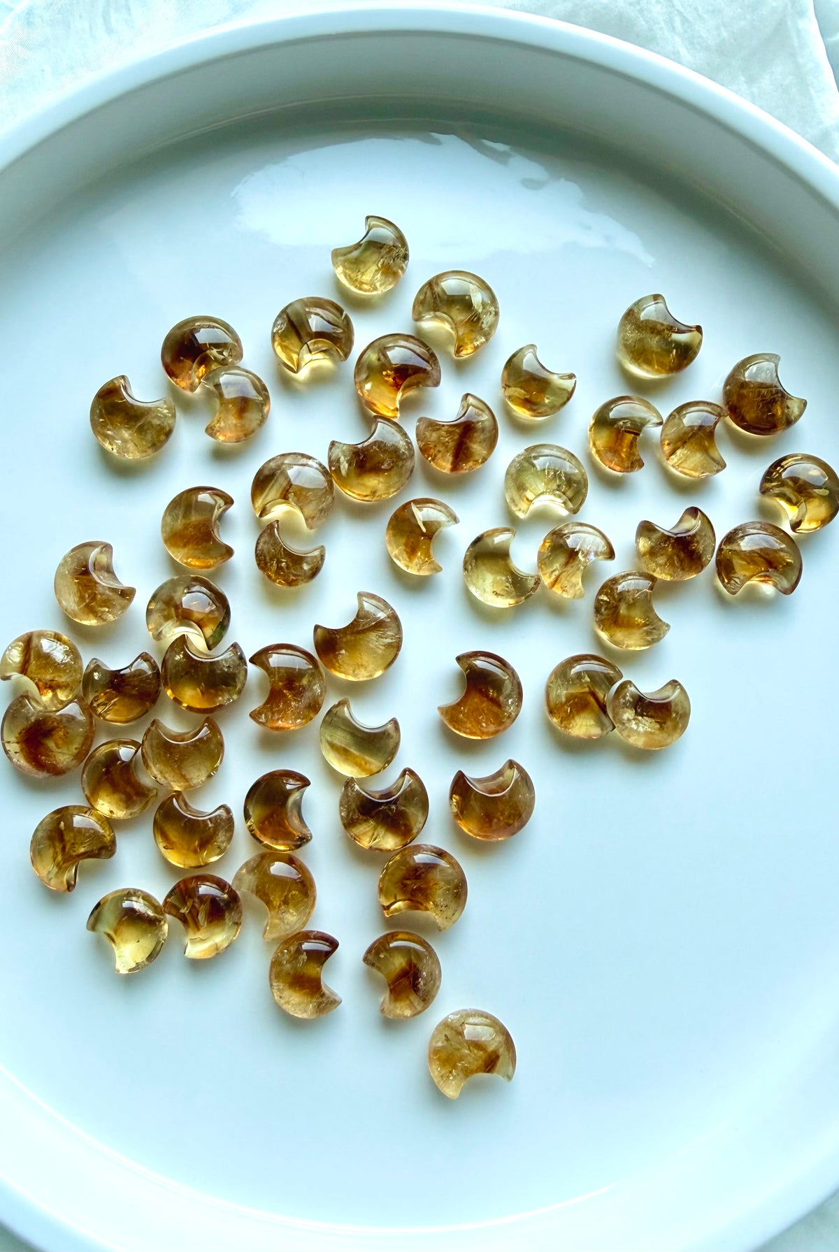 Mini Citrine moons showing natural variation in golden honey color, clarity, translucence and internal patterning