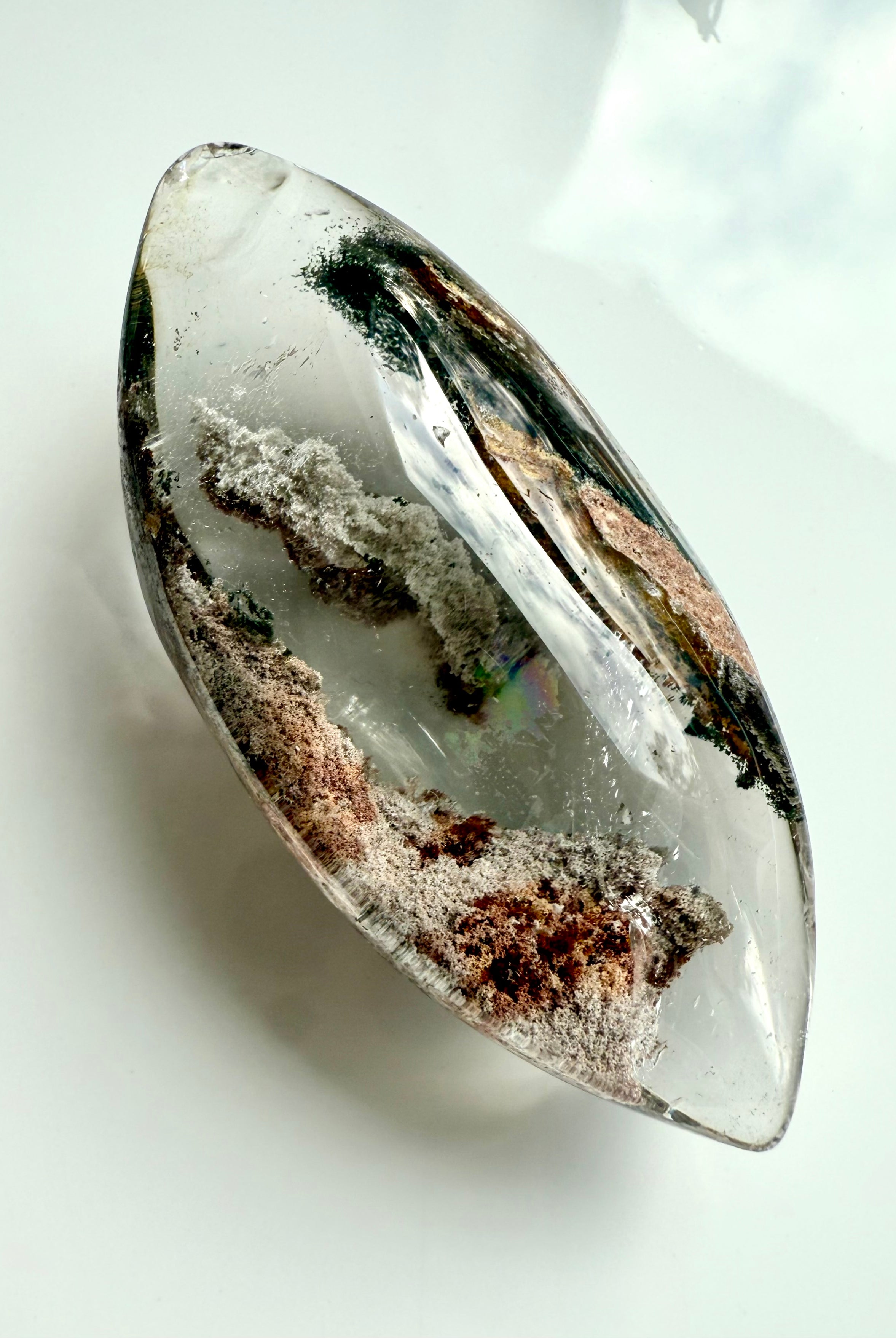 Garden Quartz marquise-shaped lens with phantom lines in earthy green, gold, rust tones, and a rainbow inclusion