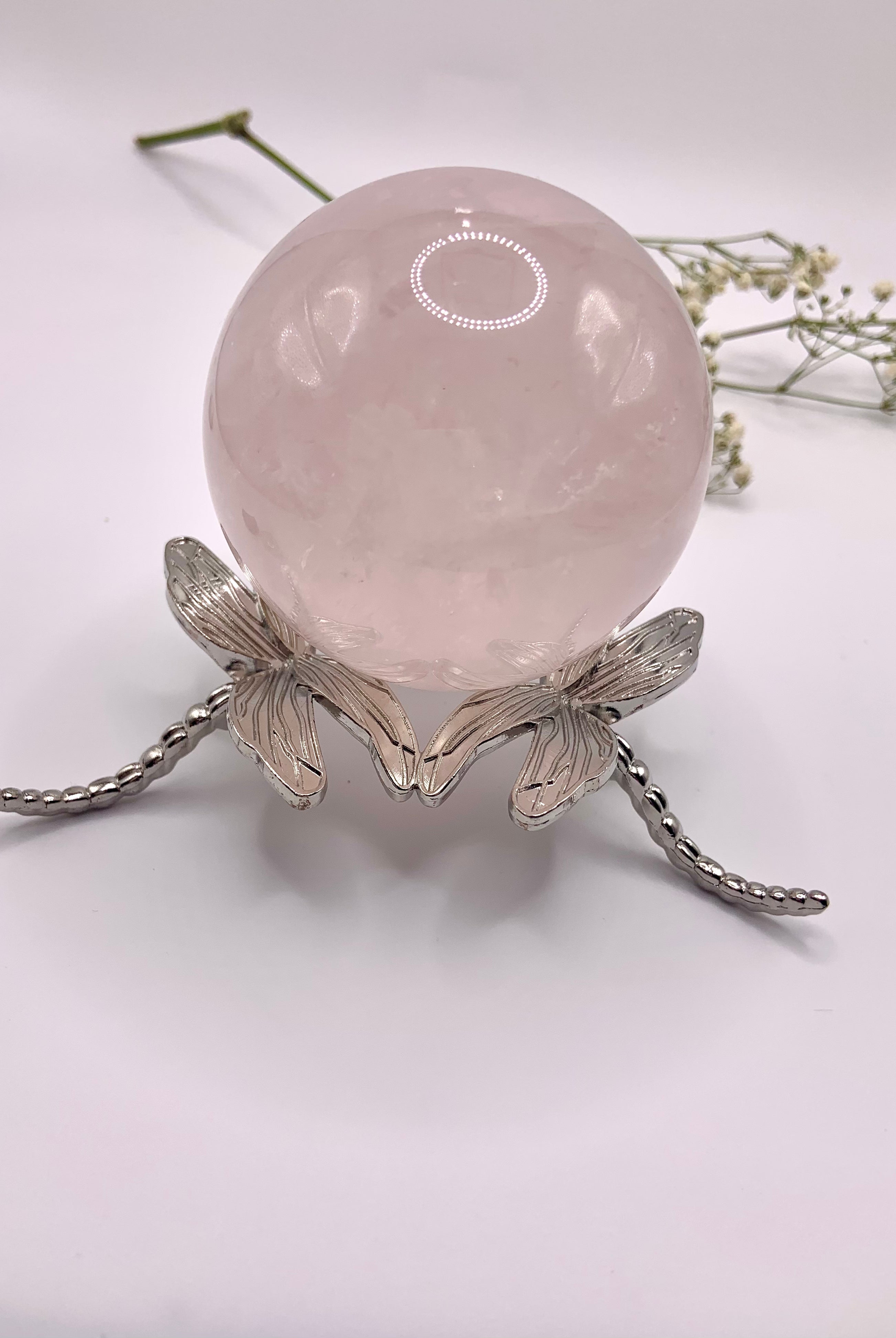 The larger dragonfly crystal sphere stand shown with a 60mm rose quartz sphere