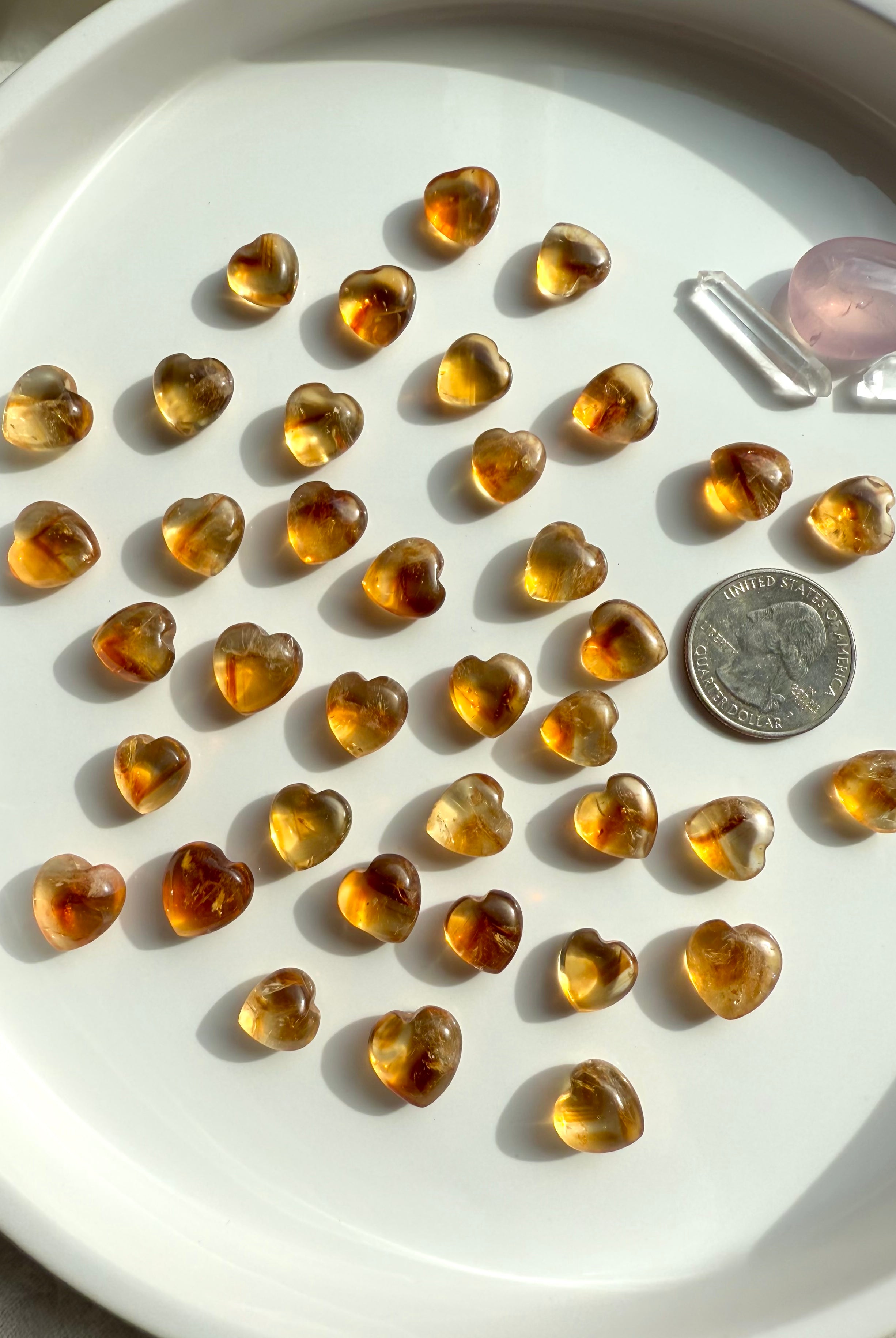 Mini Citrine Crystal Hearts shown on with a quarter for scale