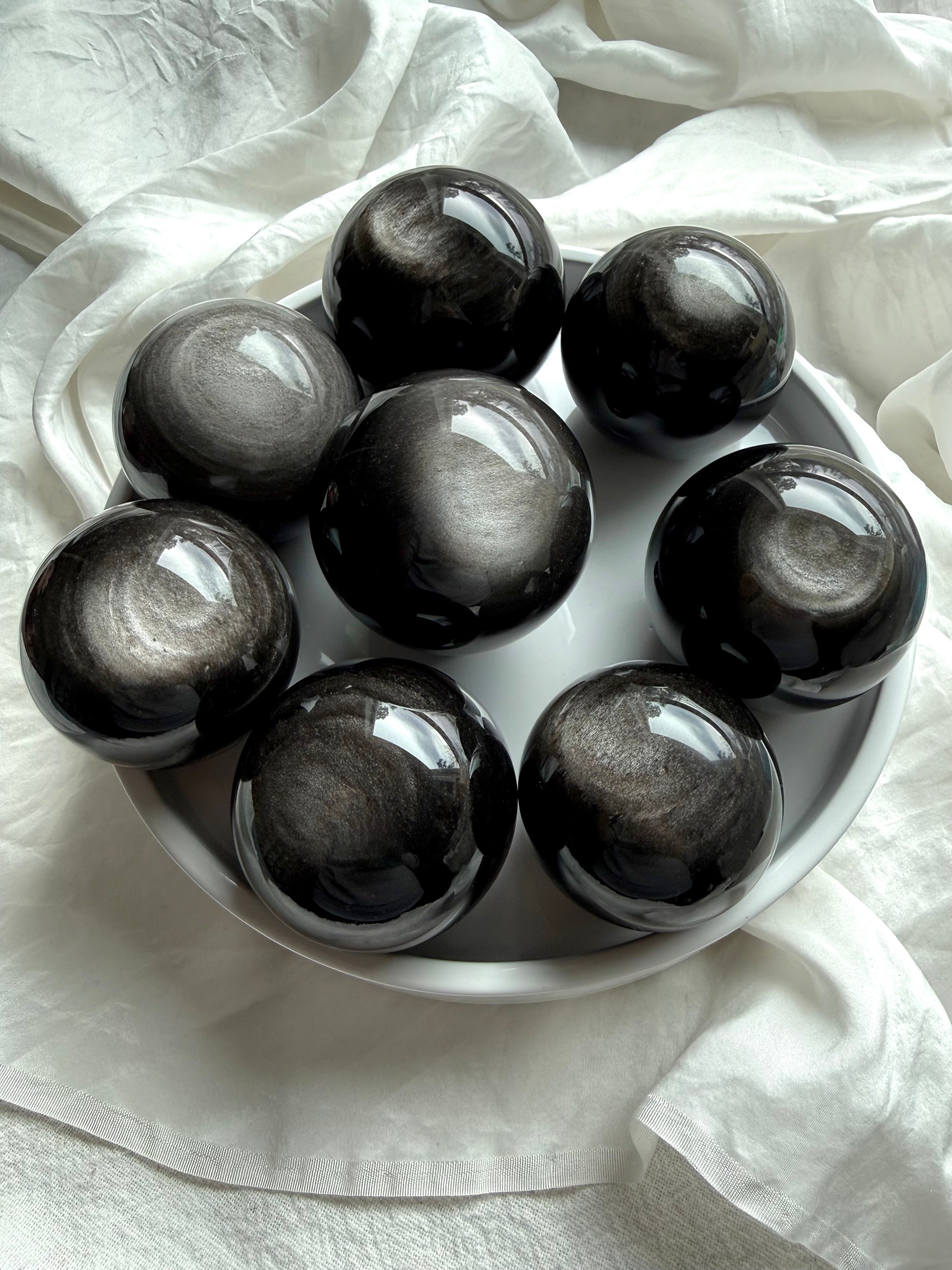 Silver Sheen Obsidian spheres displaying swirling silver flash — polished obsidian crystal balls for energy protection and insight