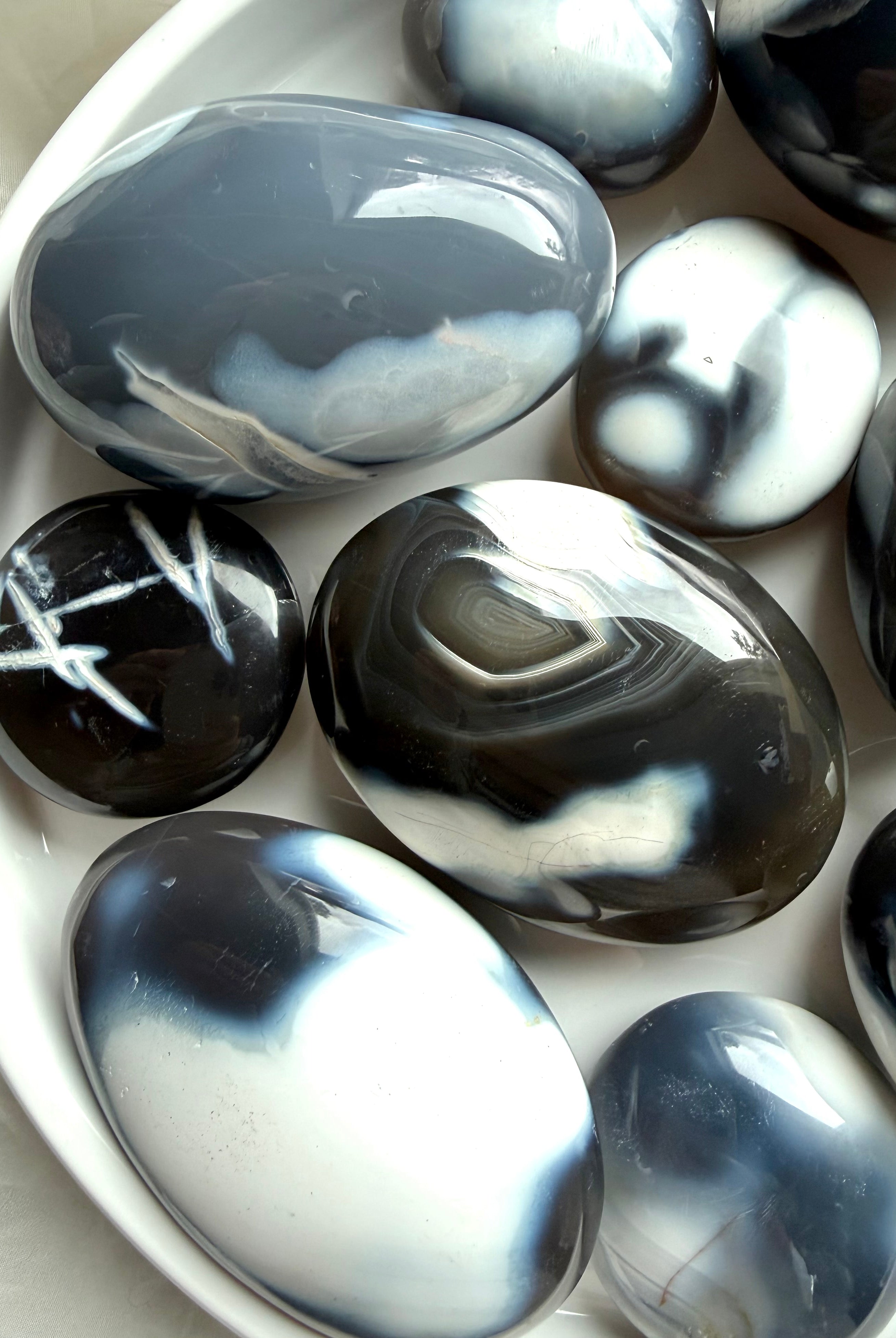 Polished Orca Agate palm stones with swirling ocean-like patterns, a soothing crystal for forgiveness and emotional balance