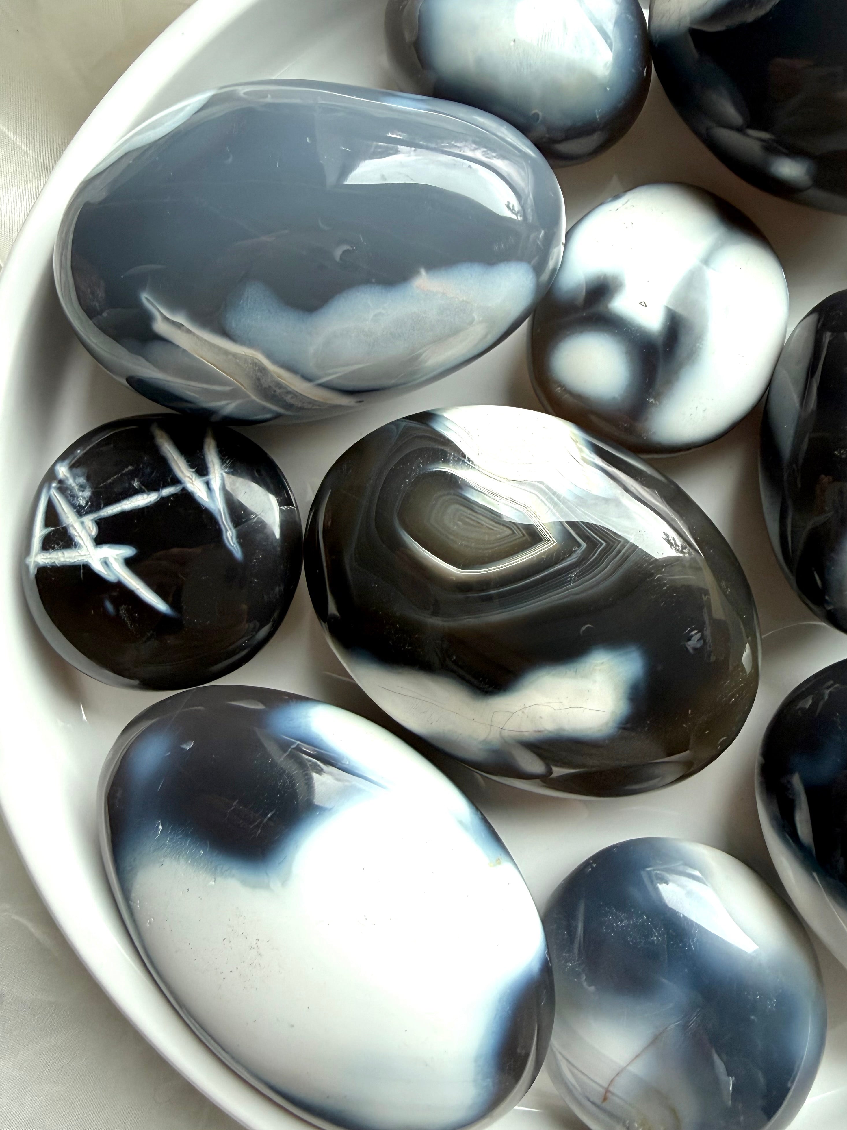 Polished Orca Agate palm stones with swirling ocean-like patterns, a soothing crystal for forgiveness and emotional balance
