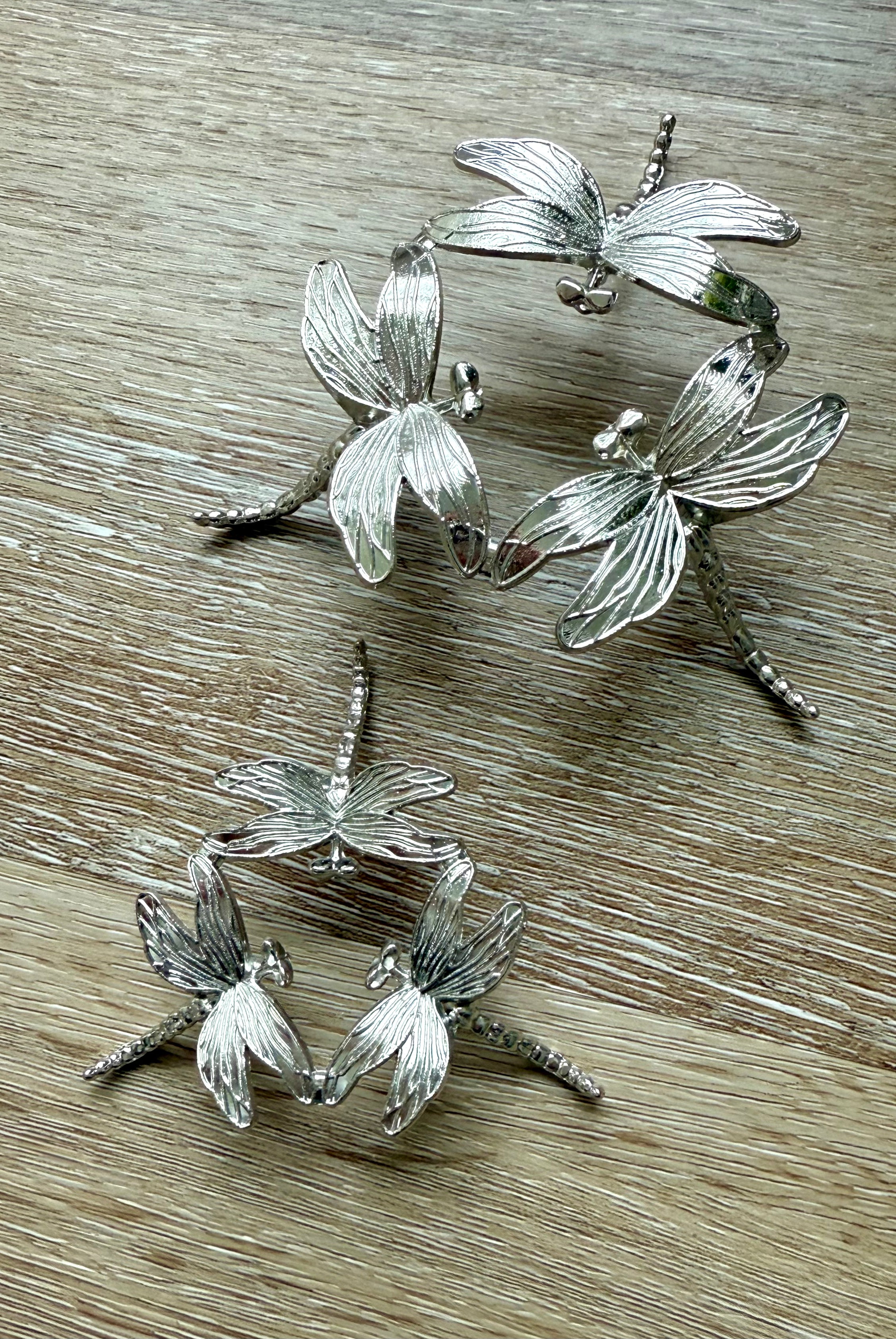 Our Metal Dragonfly Crystal Sphere Stand shown with both size options side by side for comparison