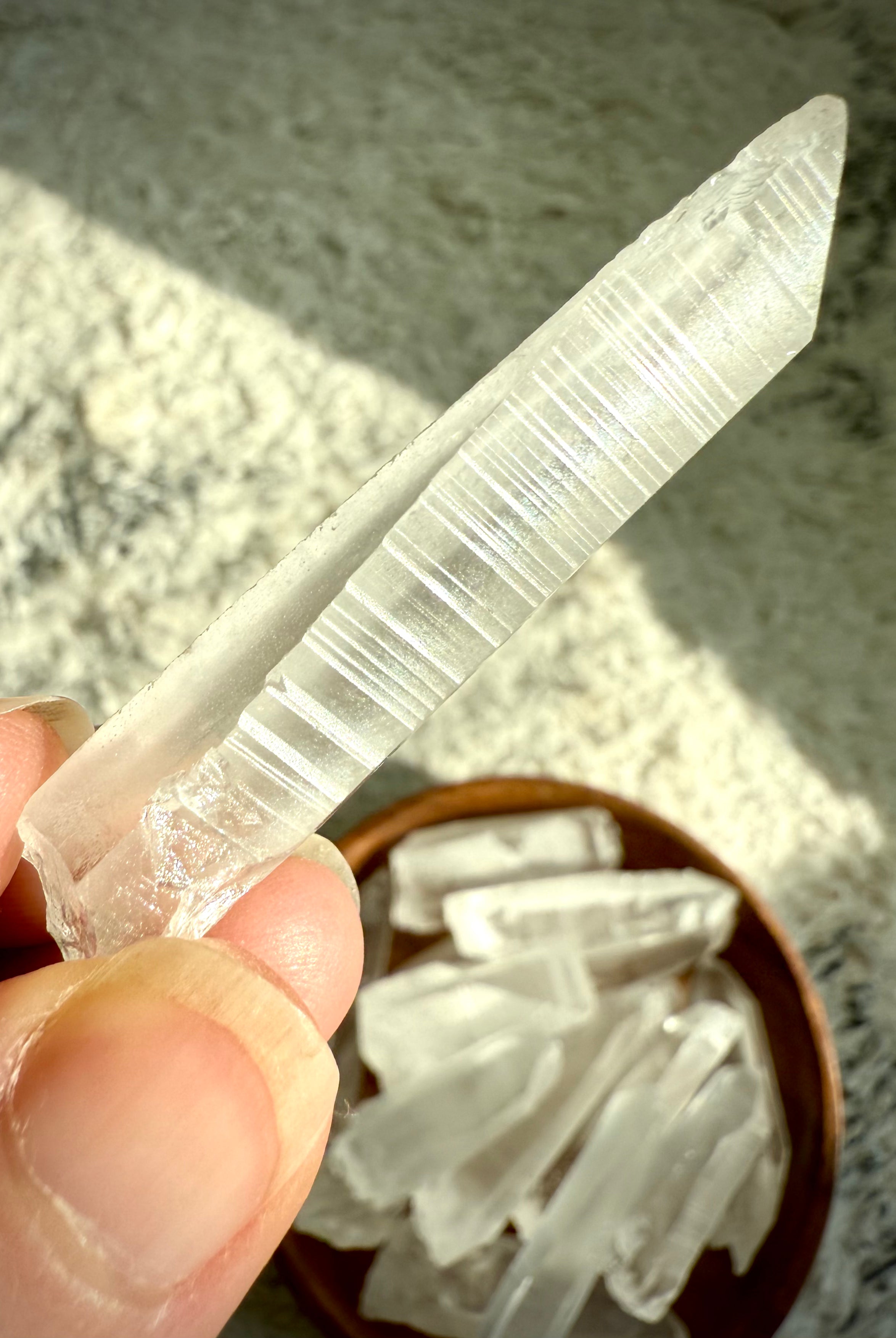 Close-up of Lemurian Seed Quartz showing horizontal ladder-like striations — signature lines believed to hold ancient wisdom & encoded light.