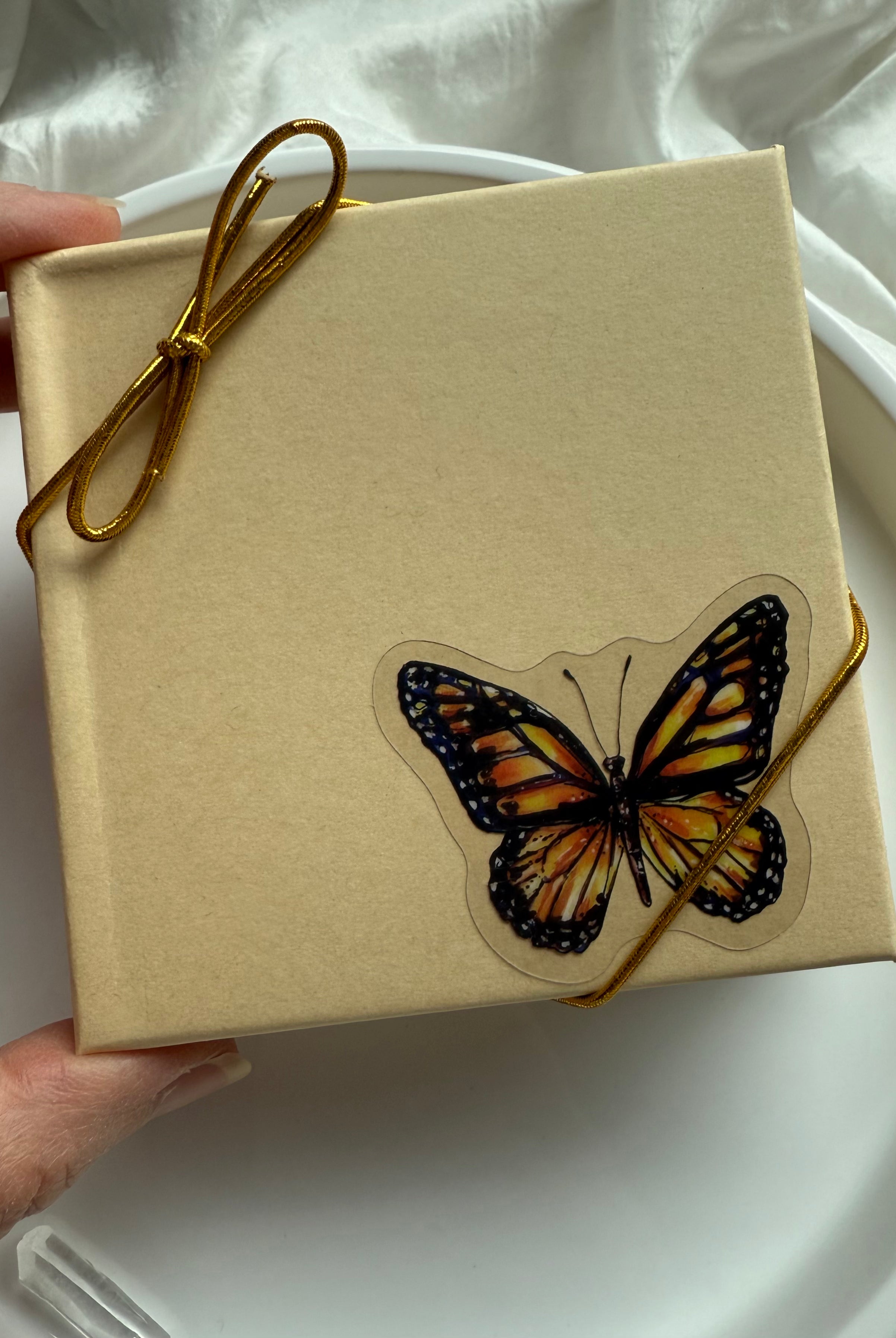 Butterfly gift box with gold cord packaging for Blue Chalcedony heart necklace, perfect for spiritual gifting.
