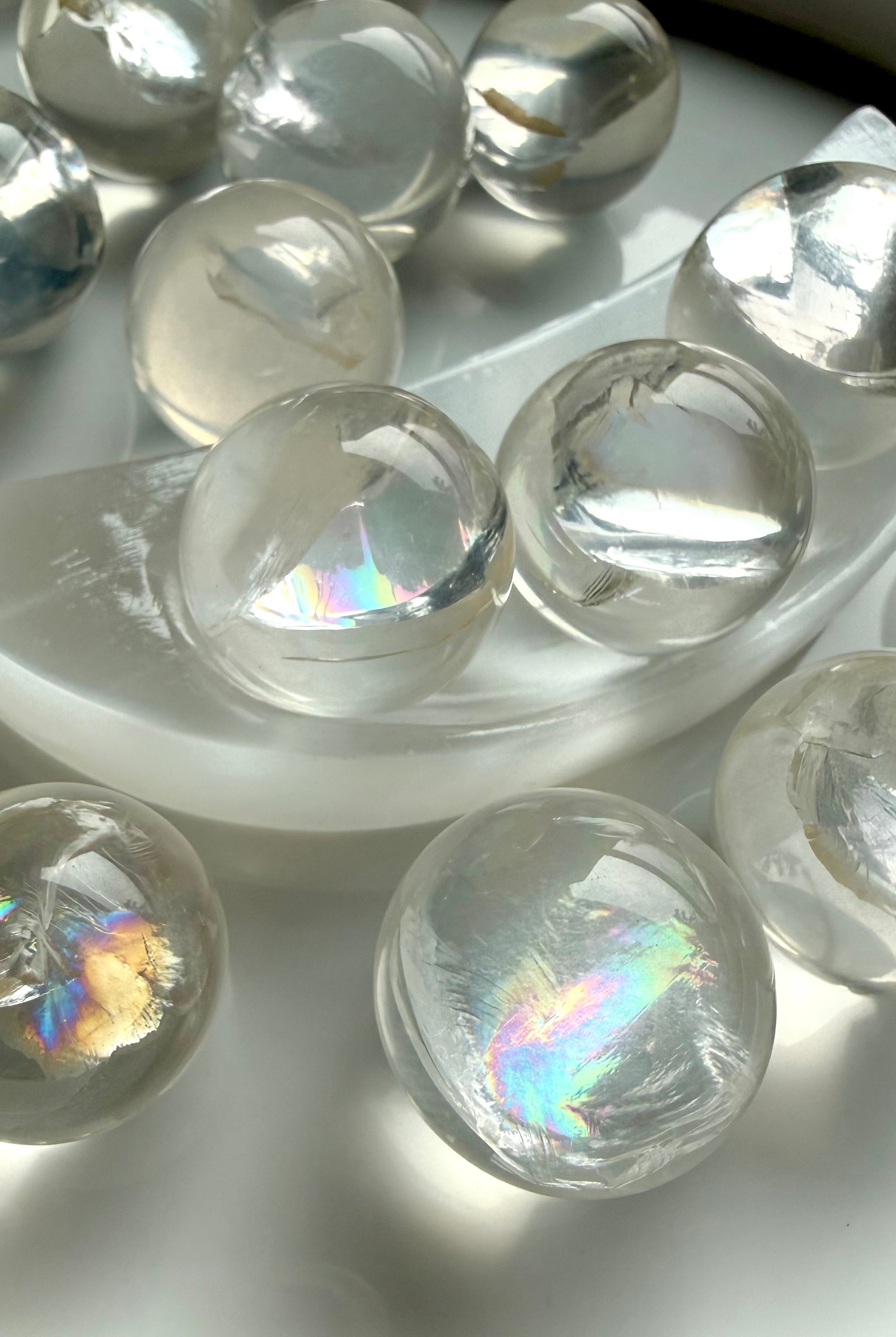 Rainbow girasol mini quartz spheres with luminous milky glow and silvery rainbows, high-vibration crystal balls for meditation and sacred space decor