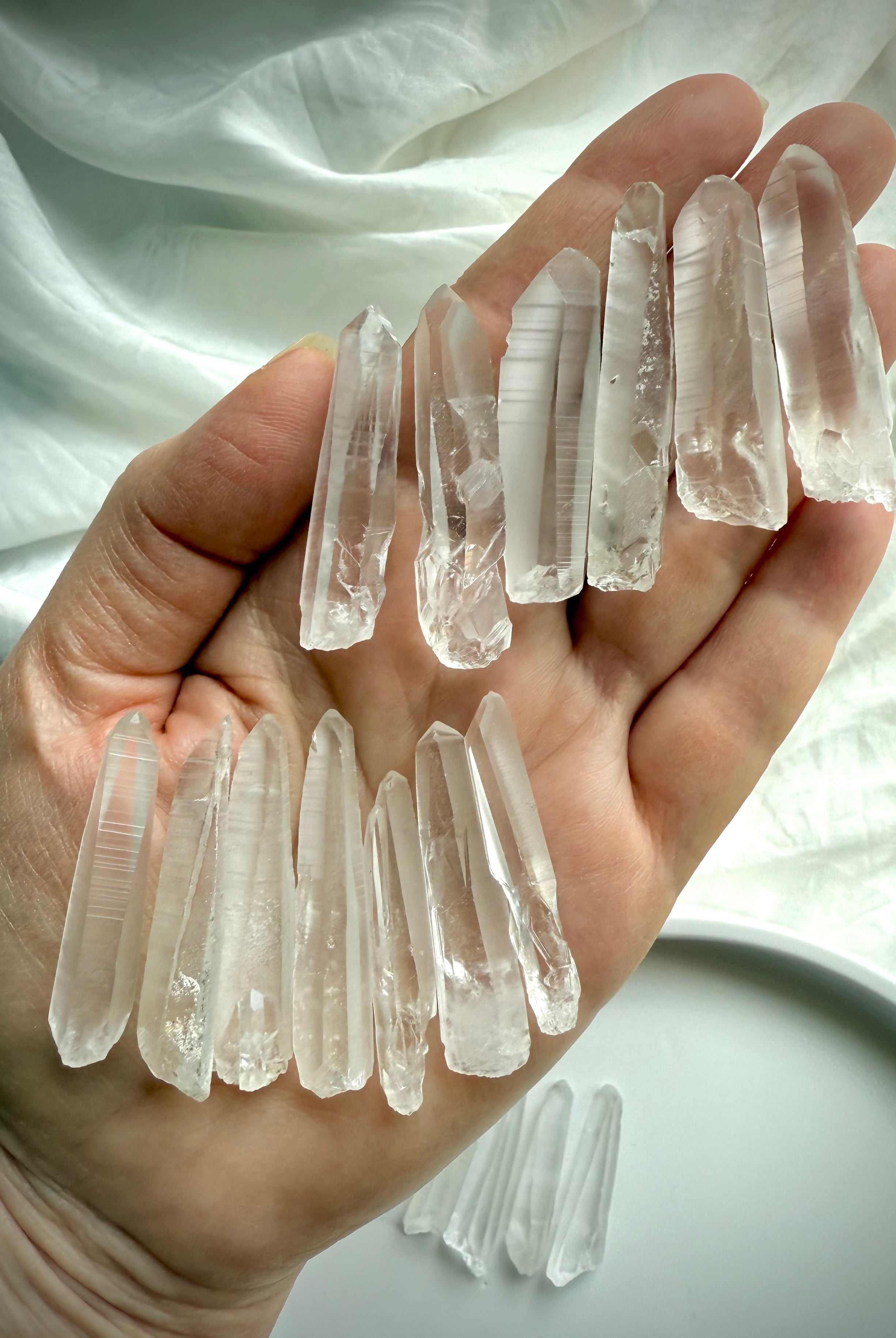 Lemurian Seed Quartz Points shown in hand to display size, striations & light-encoded texture — used for clarity, intuition & divine connection.