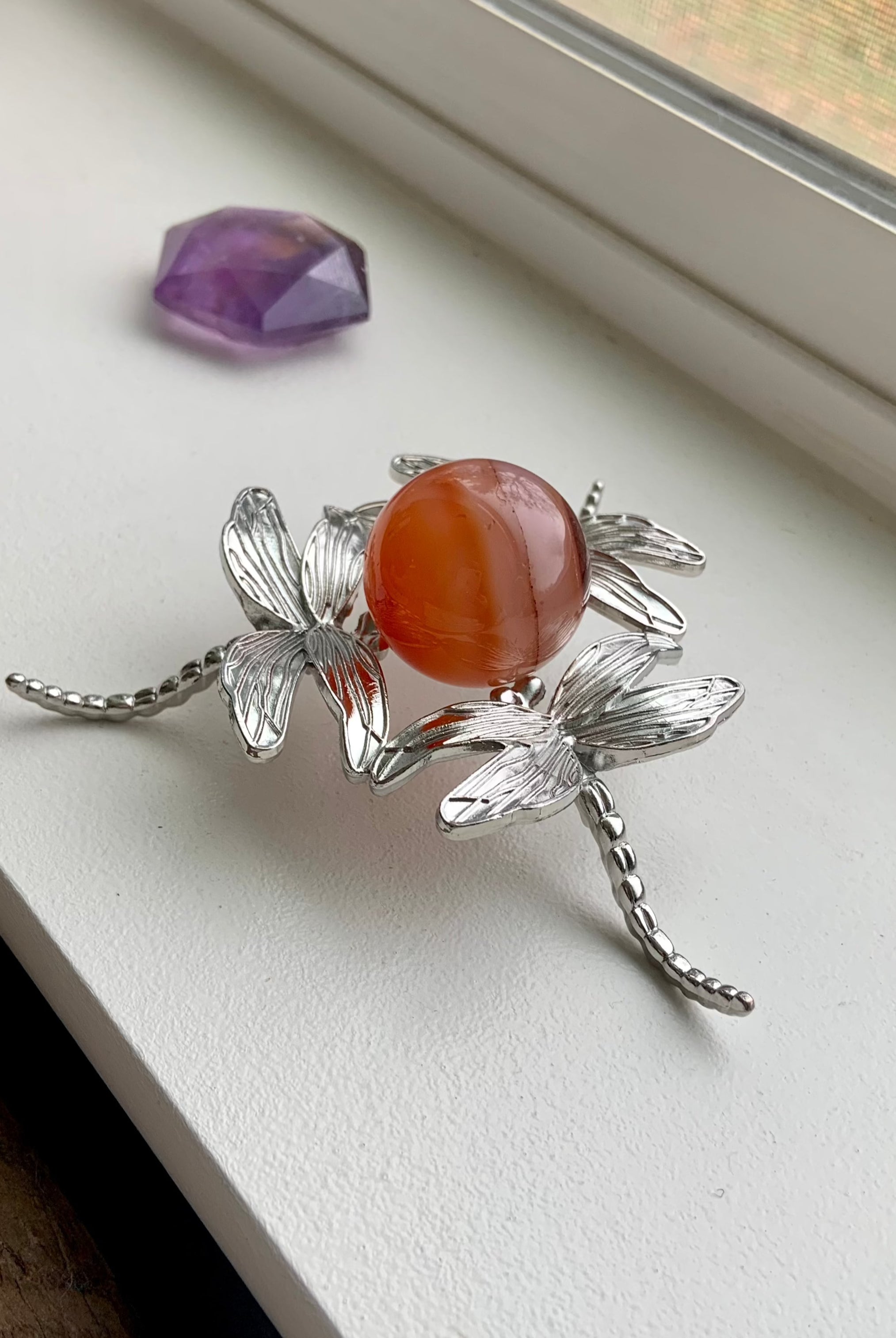 A Metal Dragonfly Crystal Sphere Stand is versatile for small to large spheres, eggs, or specimens