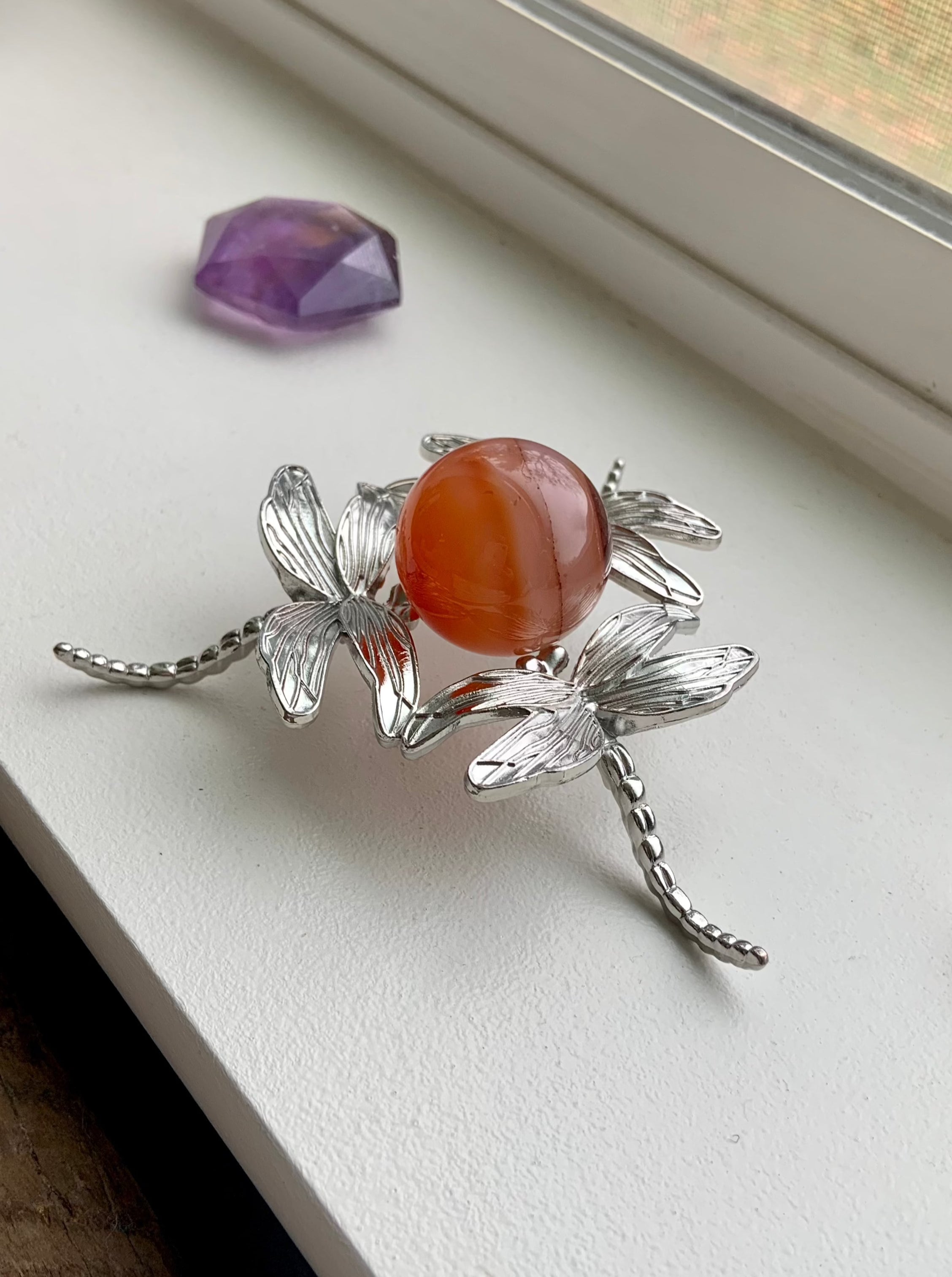 A Metal Dragonfly Crystal Sphere Stand is versatile for small to large spheres, eggs, or specimens