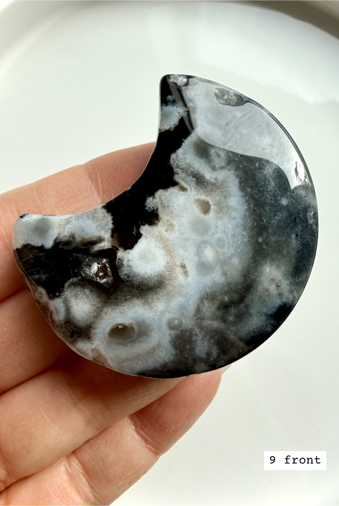 black flower agate moon carving #9 front showing crescent shape with bold white bloom formations