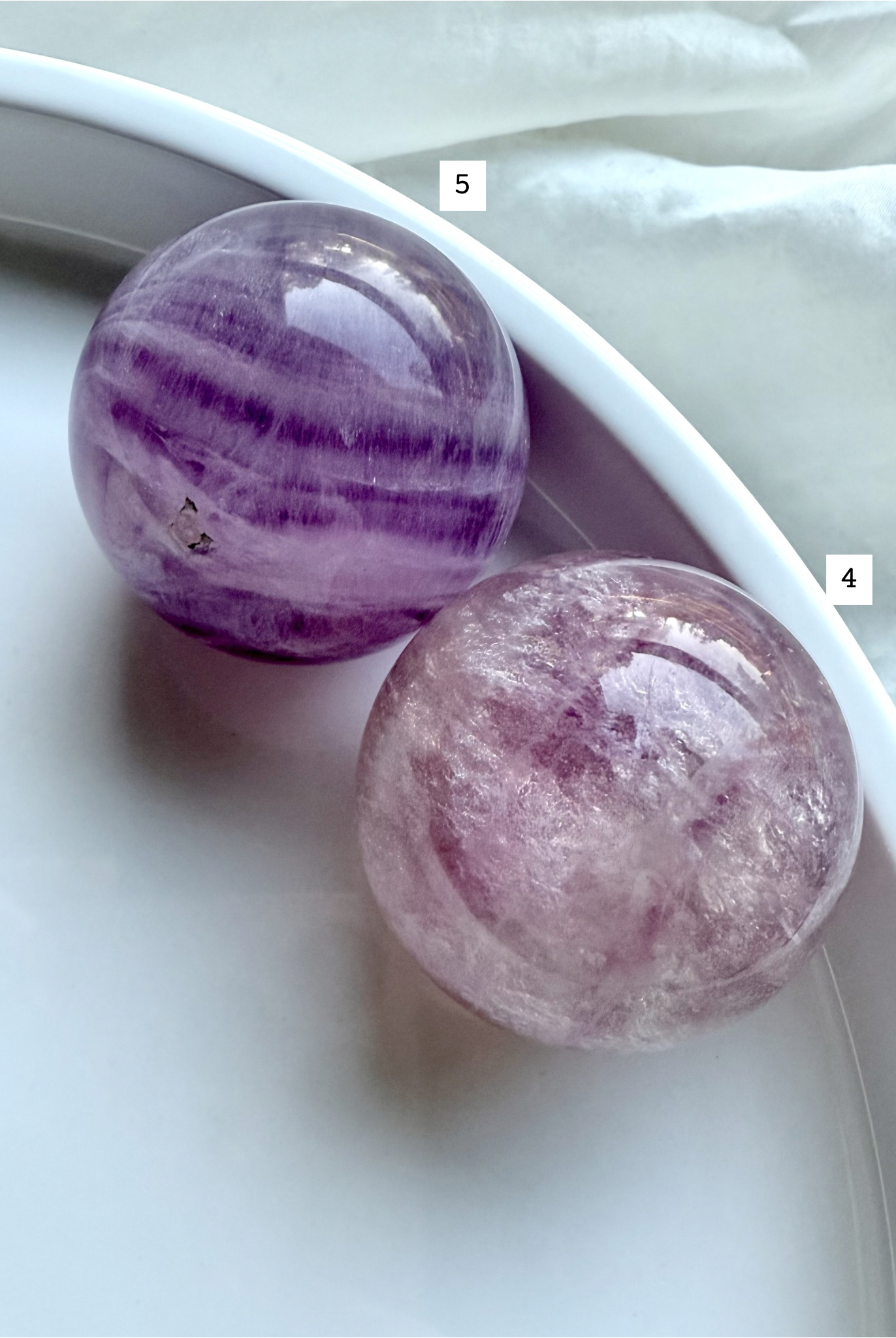 closeup of Silky Magenta Fluorite spheres showing layered lavender and blush crystal patterns