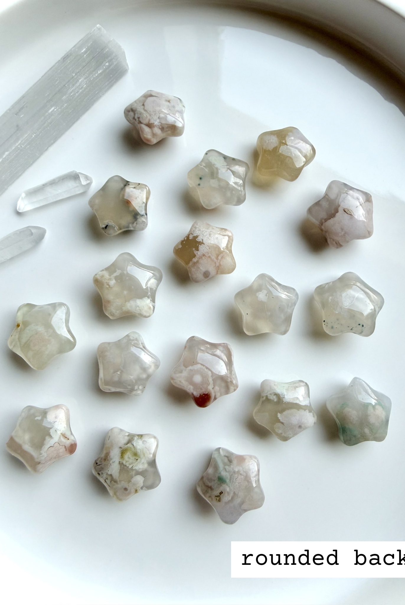 Flower Agate starfish carvings showing smooth rounded backs with natural blossom patterns and soft translucent glow
