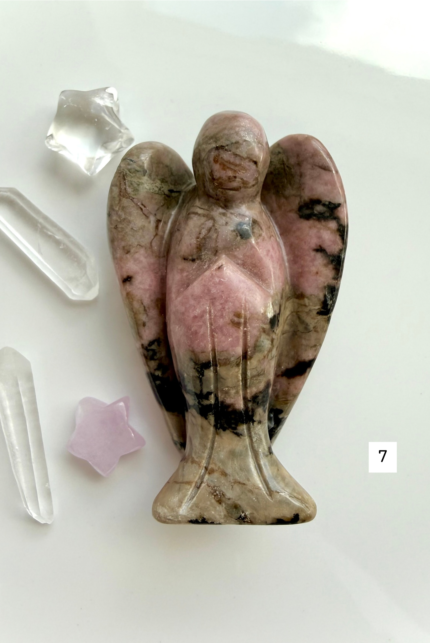 Natural Rhodonite angel crystal with unique matrix patterns for grief support and emotional healing