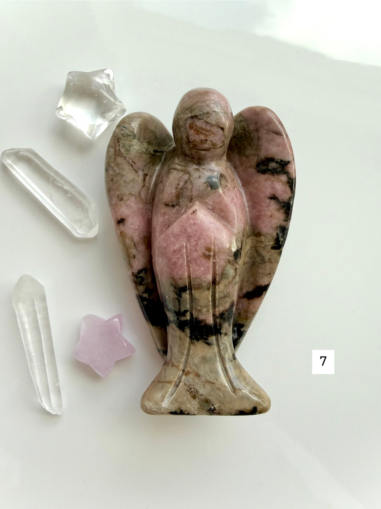 Natural Rhodonite angel crystal with unique matrix patterns for grief support and emotional healing