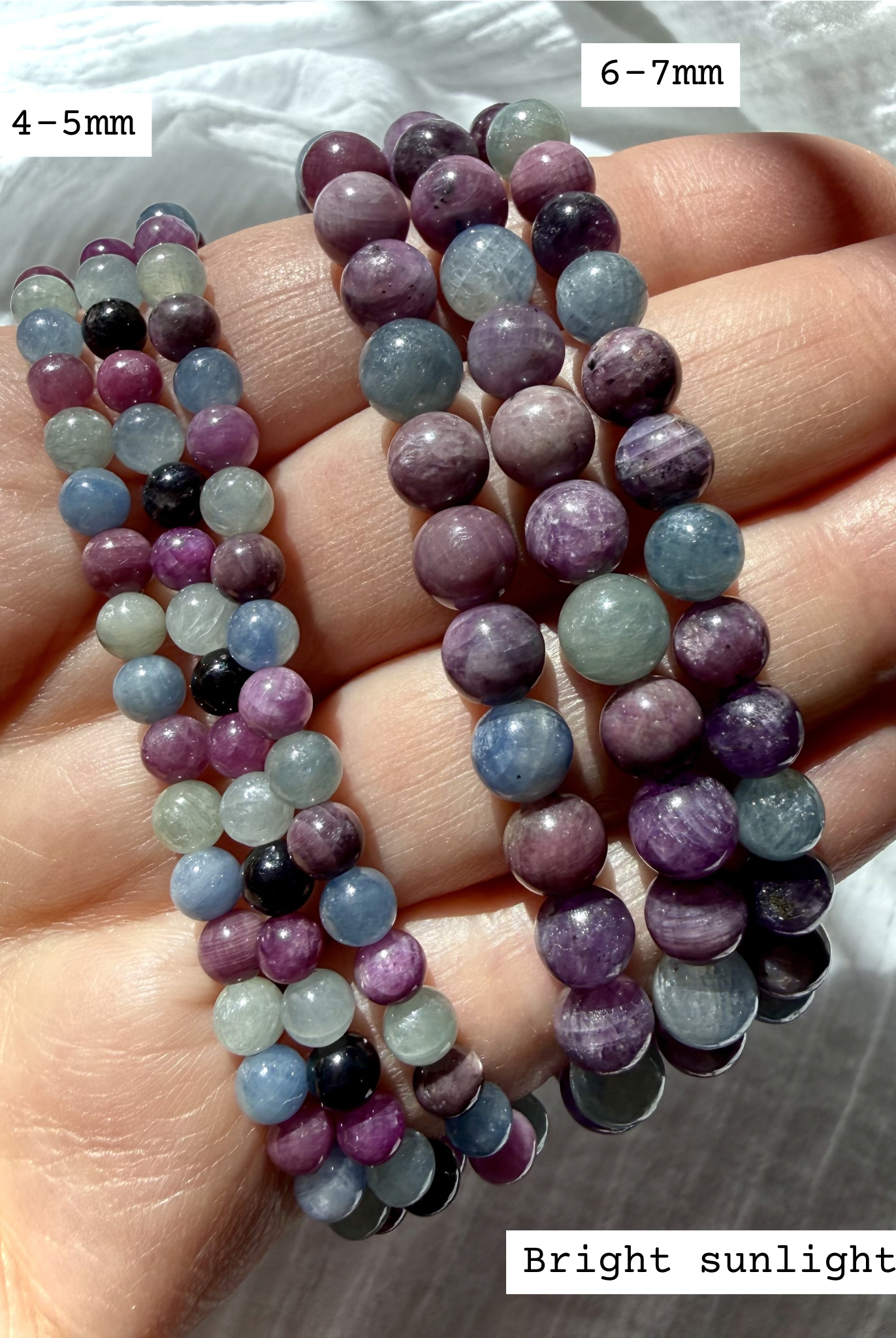stacked Ruby Sapphire crystal bracelets worn on hand showing available bracelet sizes