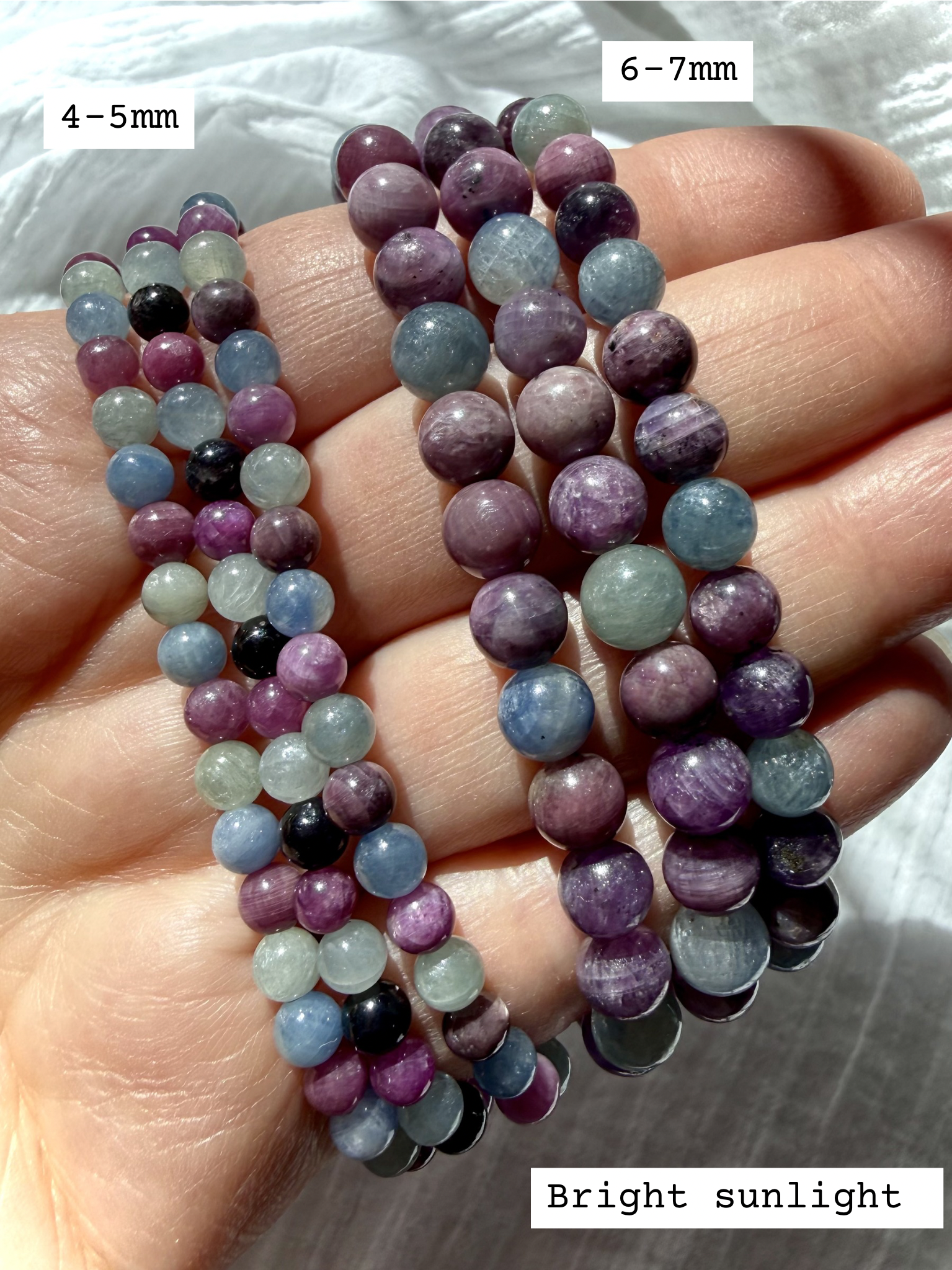 stacked Ruby Sapphire crystal bracelets worn on hand showing available bracelet sizes