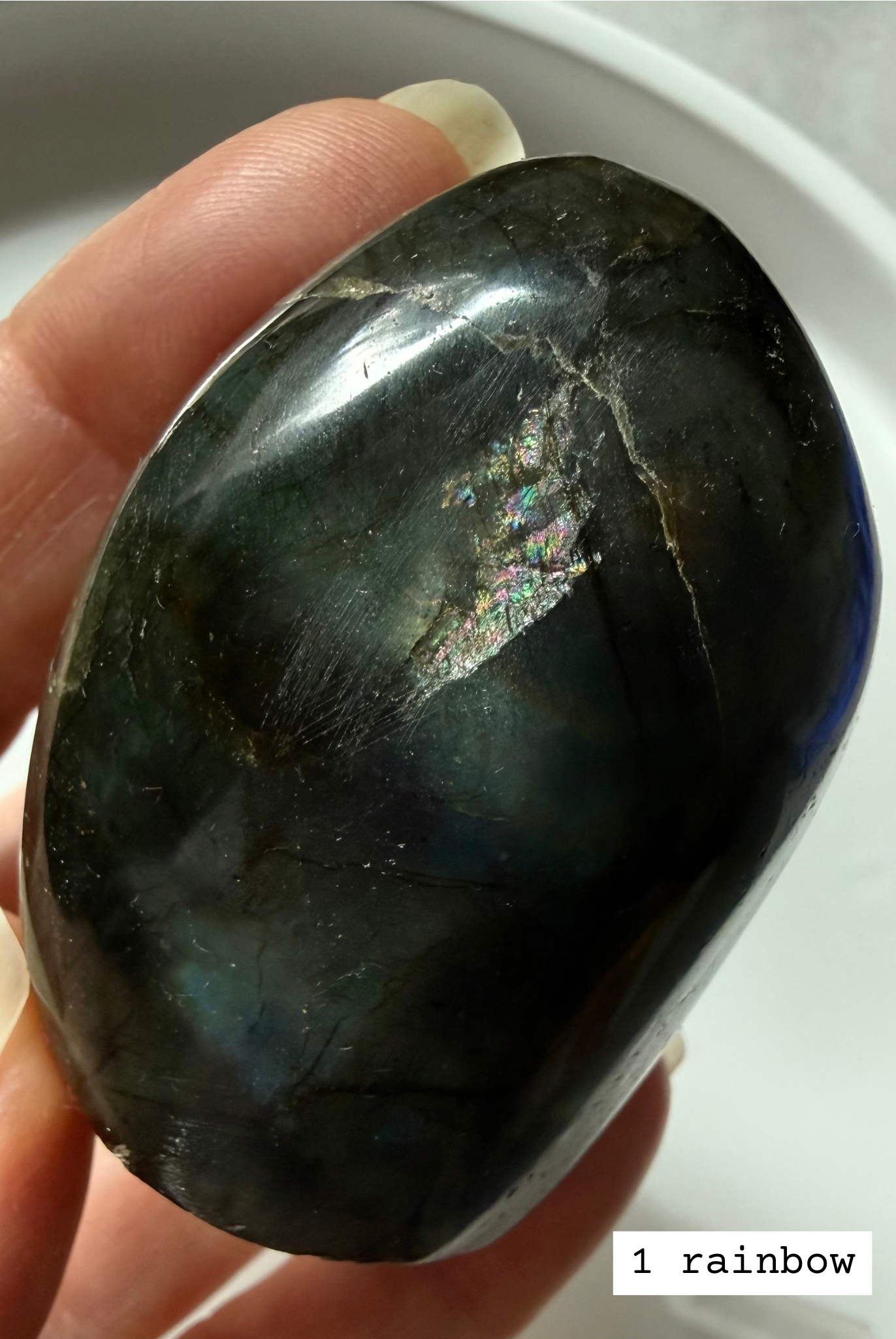 Closeup of polished labradorite freeform showing unique rainbow flash.