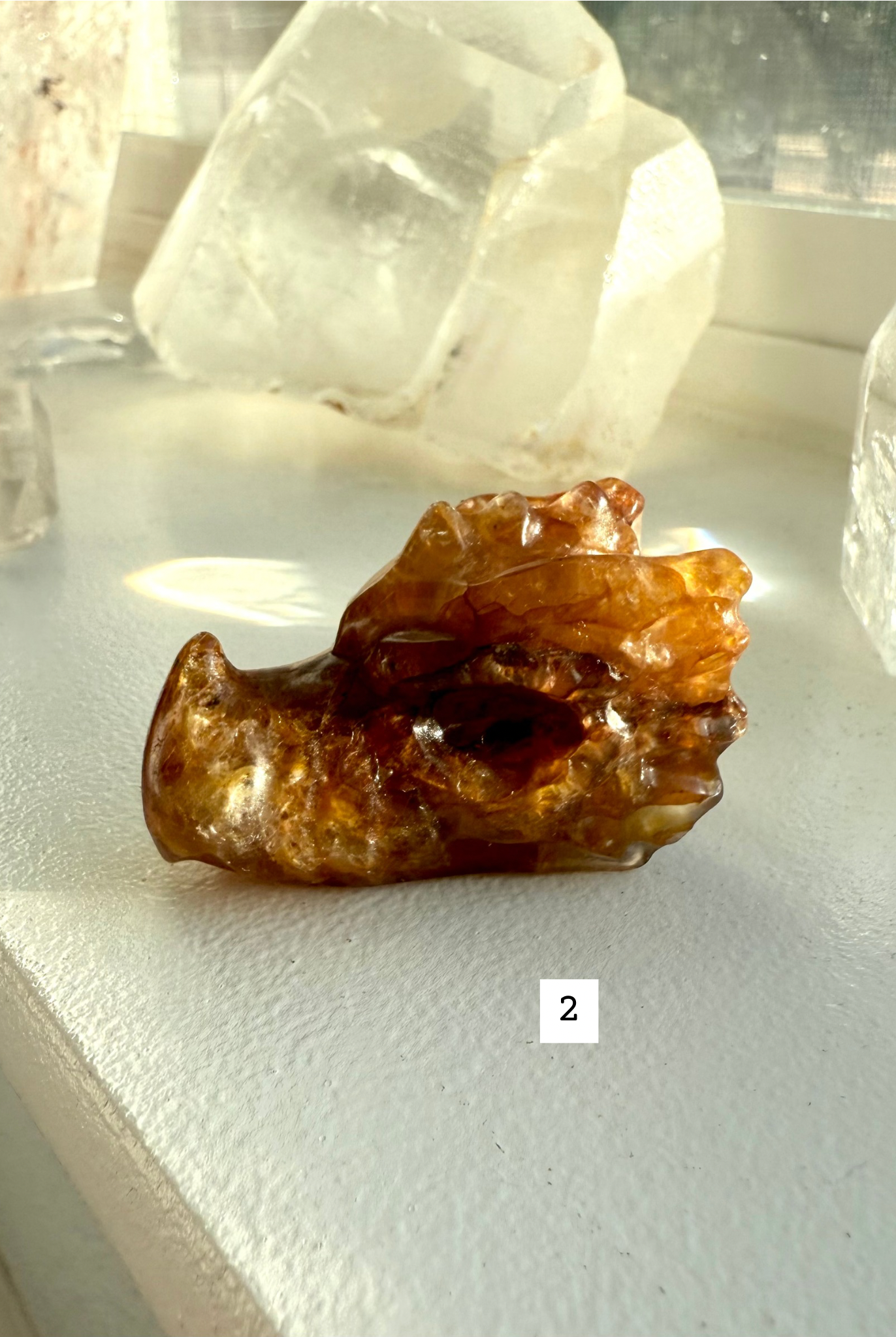 Dark golden-brown Golden Healer Quartz dragon head carving with hematite inclusions — gemstone figurine for energy work and spiritual protection.