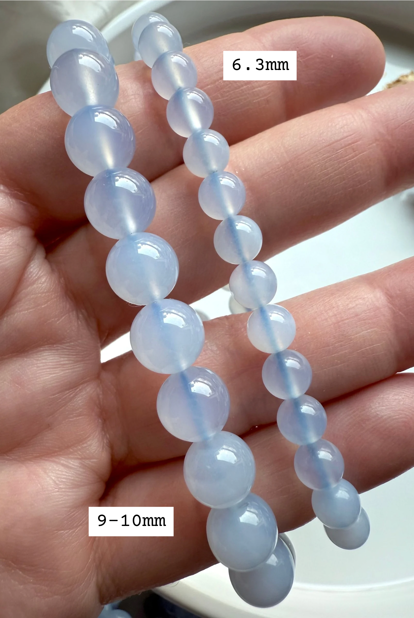 Blue Chalcedony stretch bracelets in 9–10mm and 6.3mm sizes — calming blue crystal beads for peace, communication, and throat chakra healing.