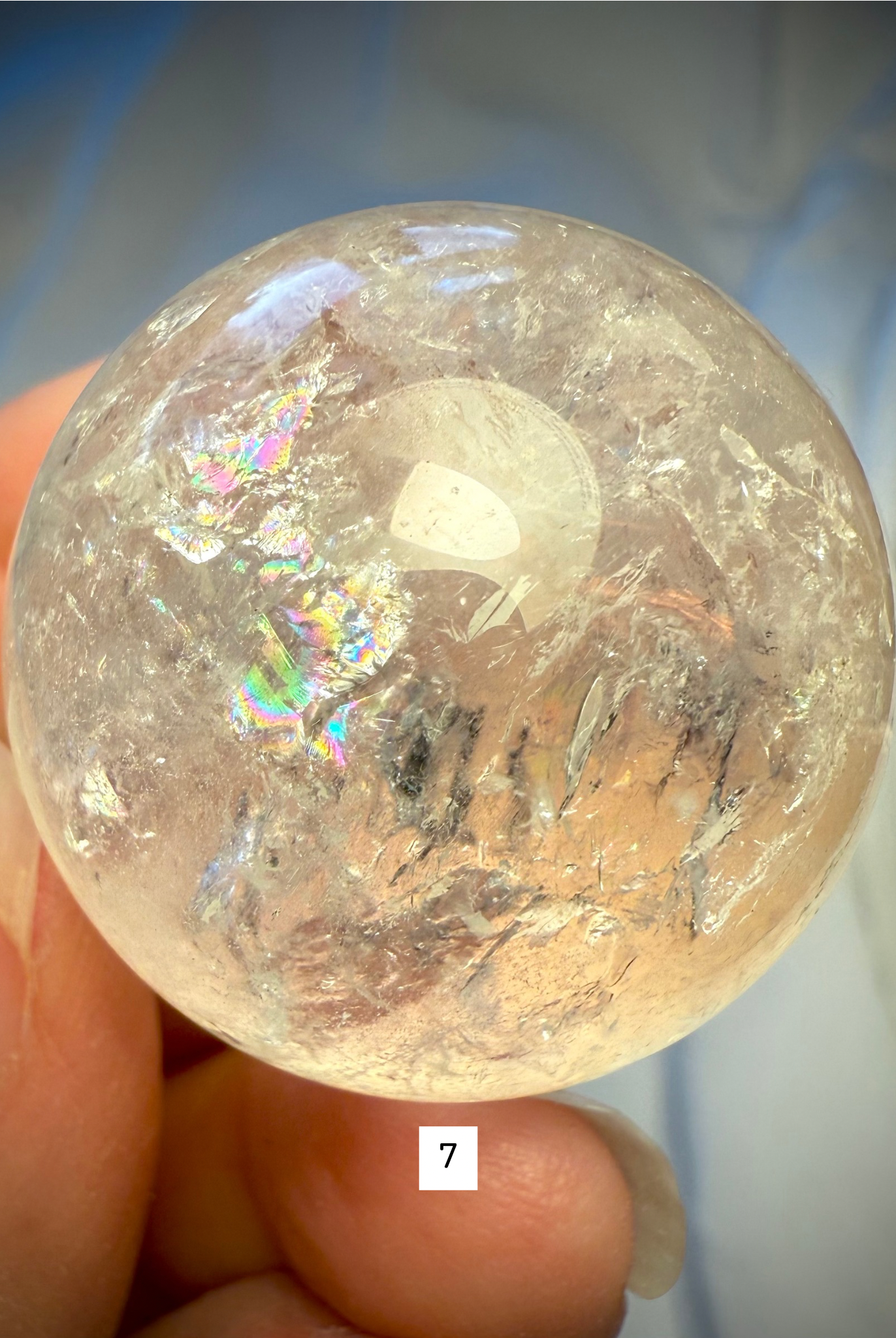 Rainbow Quartz sphere #7 glowing with radiant inner color, ideal for meditation and chakra alignment work.