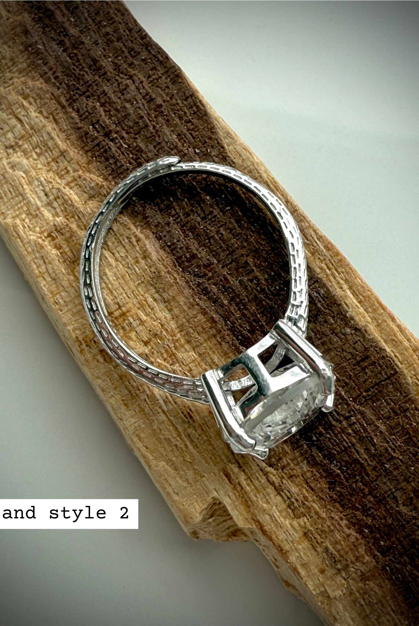 side view of option 2: sterling silver moon ring with adjustable band on wooden surface