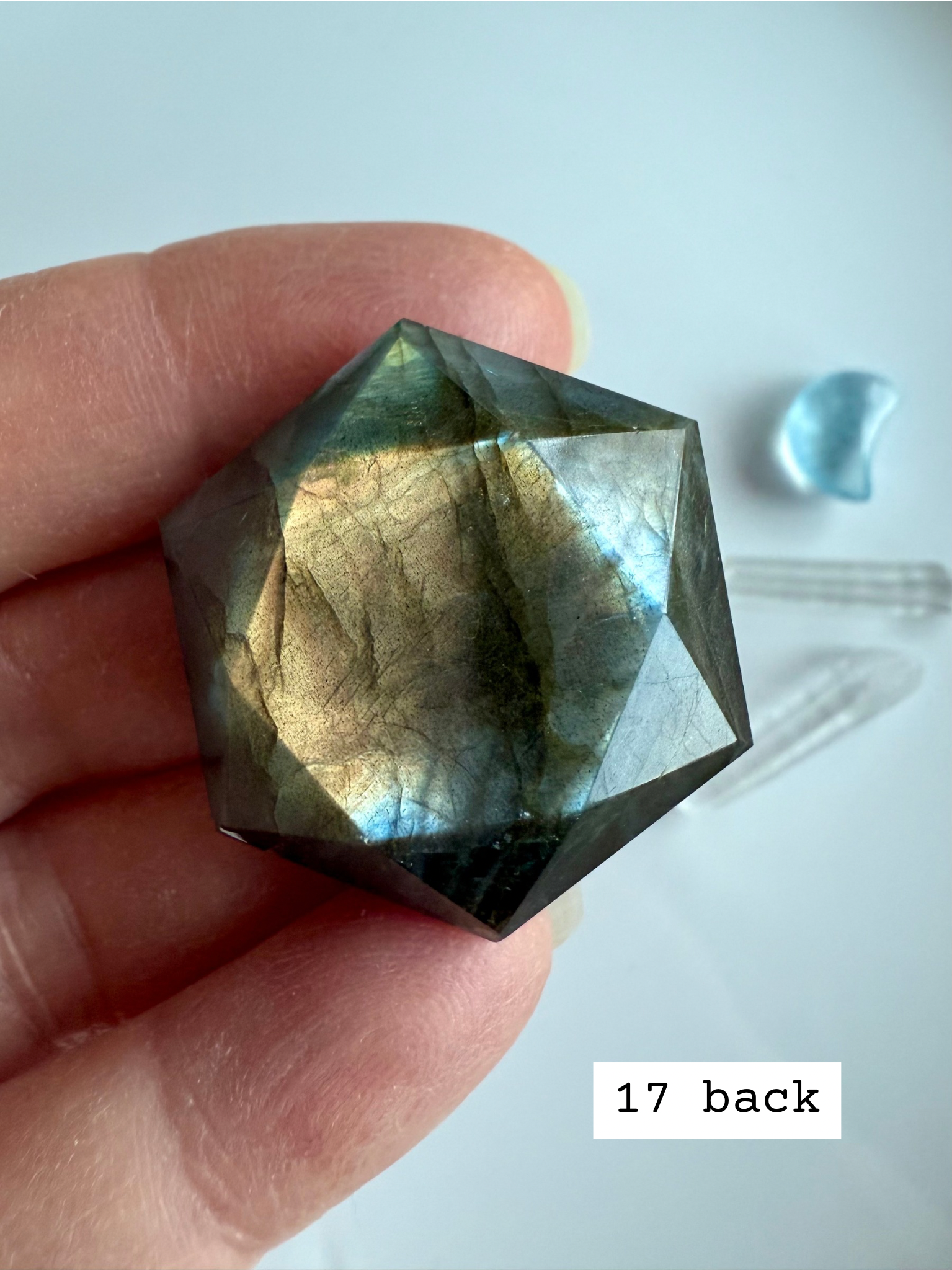 faceted labradorite hexagon with soft gold blue flash held in hand star of david labradorite crystal for spiritual insight