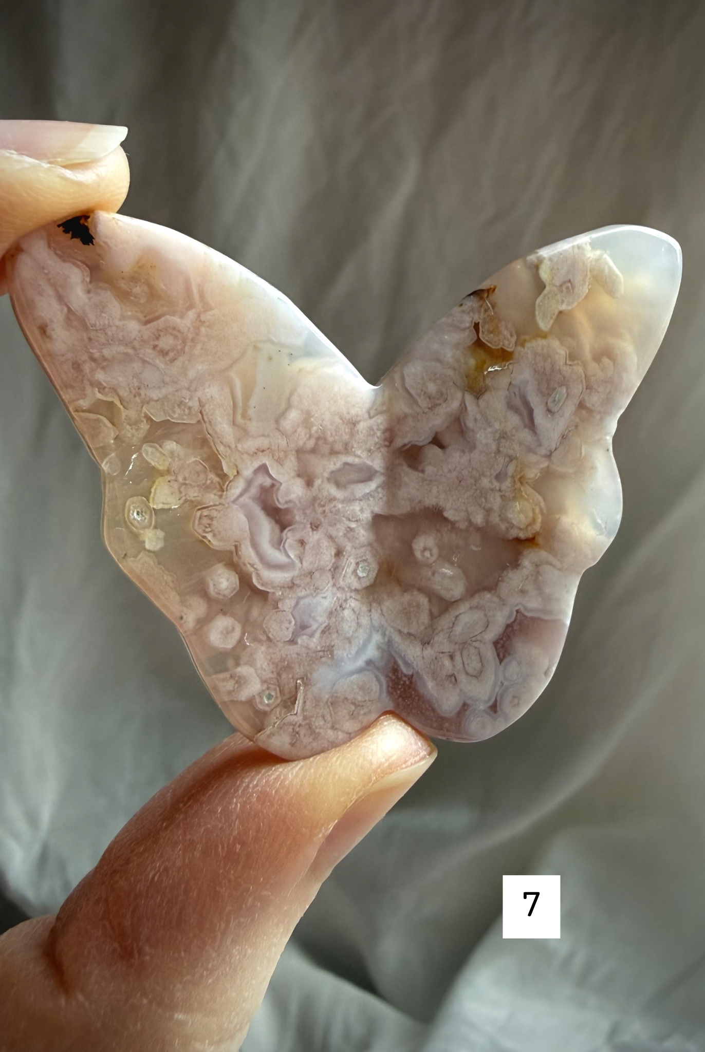 Flower Agate butterfly crystal carving #7 held in hand – detailed pink blossom agate butterfly