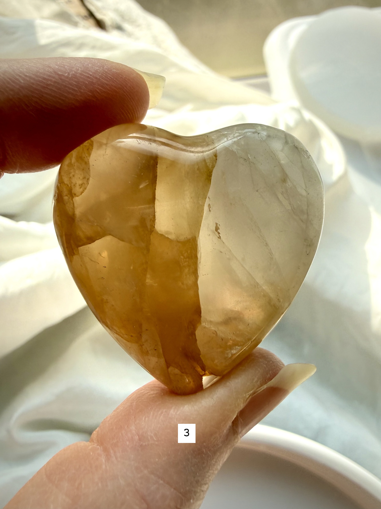golden healer quartz heart number 3 with bold golden inclusions and layered internal structure