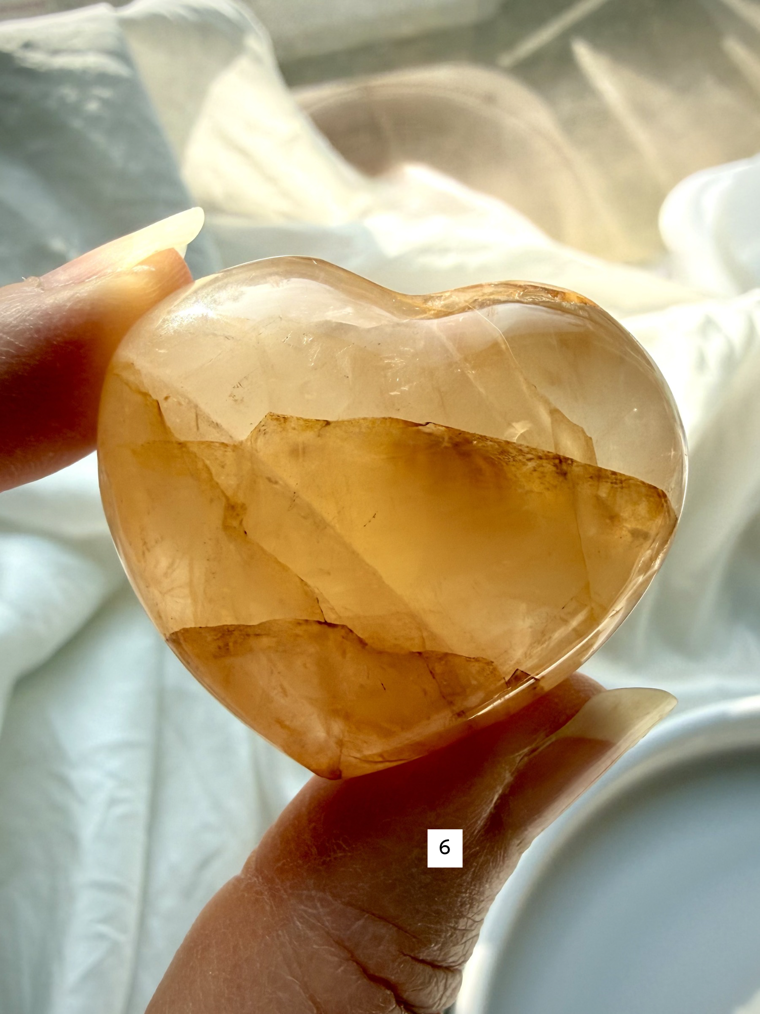 golden healer quartz heart number 6 with warm golden tones and flowing mineral inclusions