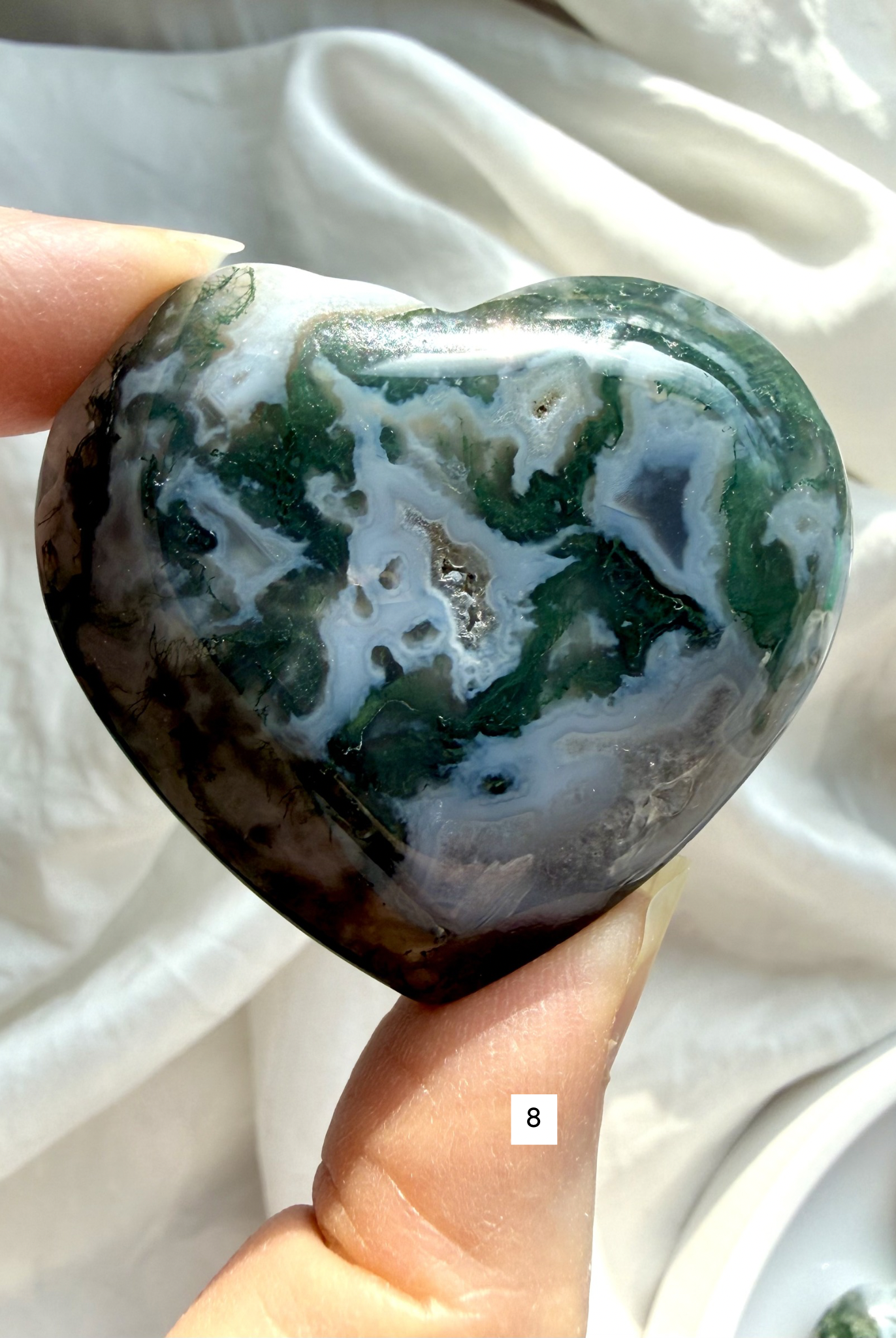 moss agate heart carving option 8 in hand with layered green inclusions and natural chalcedony pattern