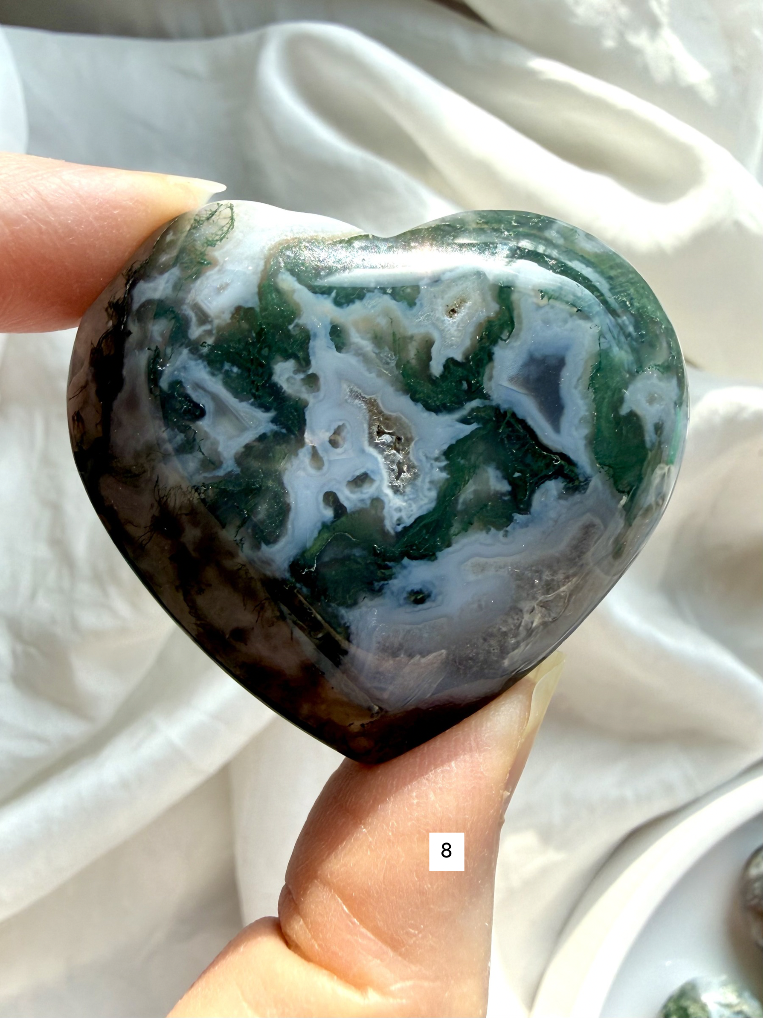 moss agate heart carving option 8 in hand with layered green inclusions and natural chalcedony pattern