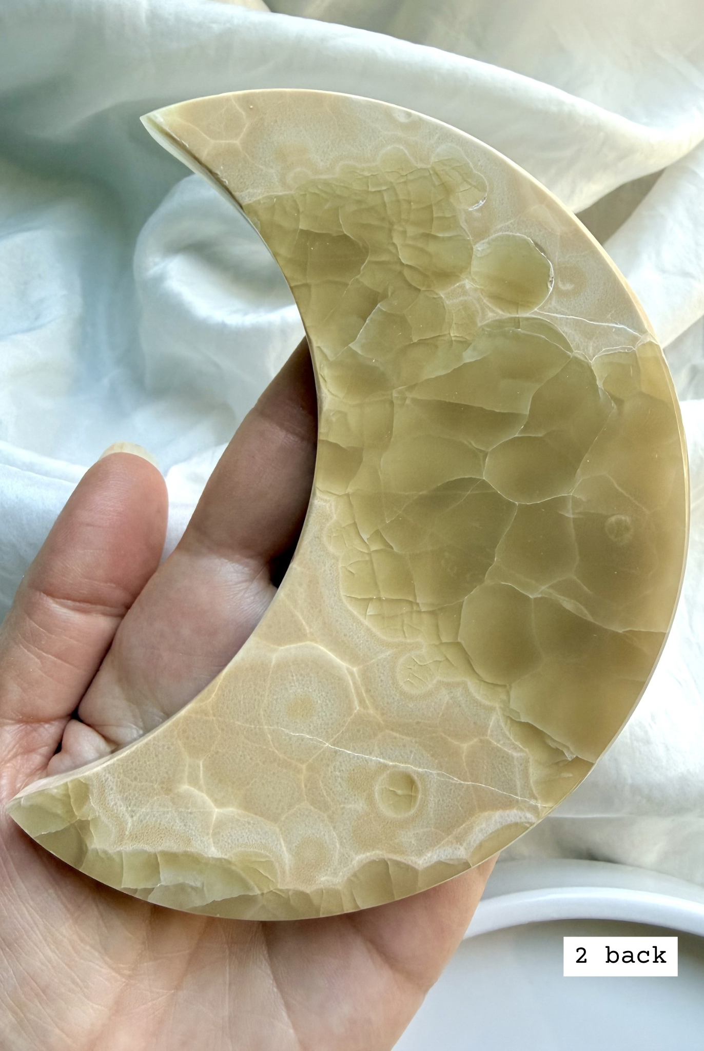 white onyx crescent moon plate # 2 back natural Mexican onyx crystal showing banding and earthy pattern