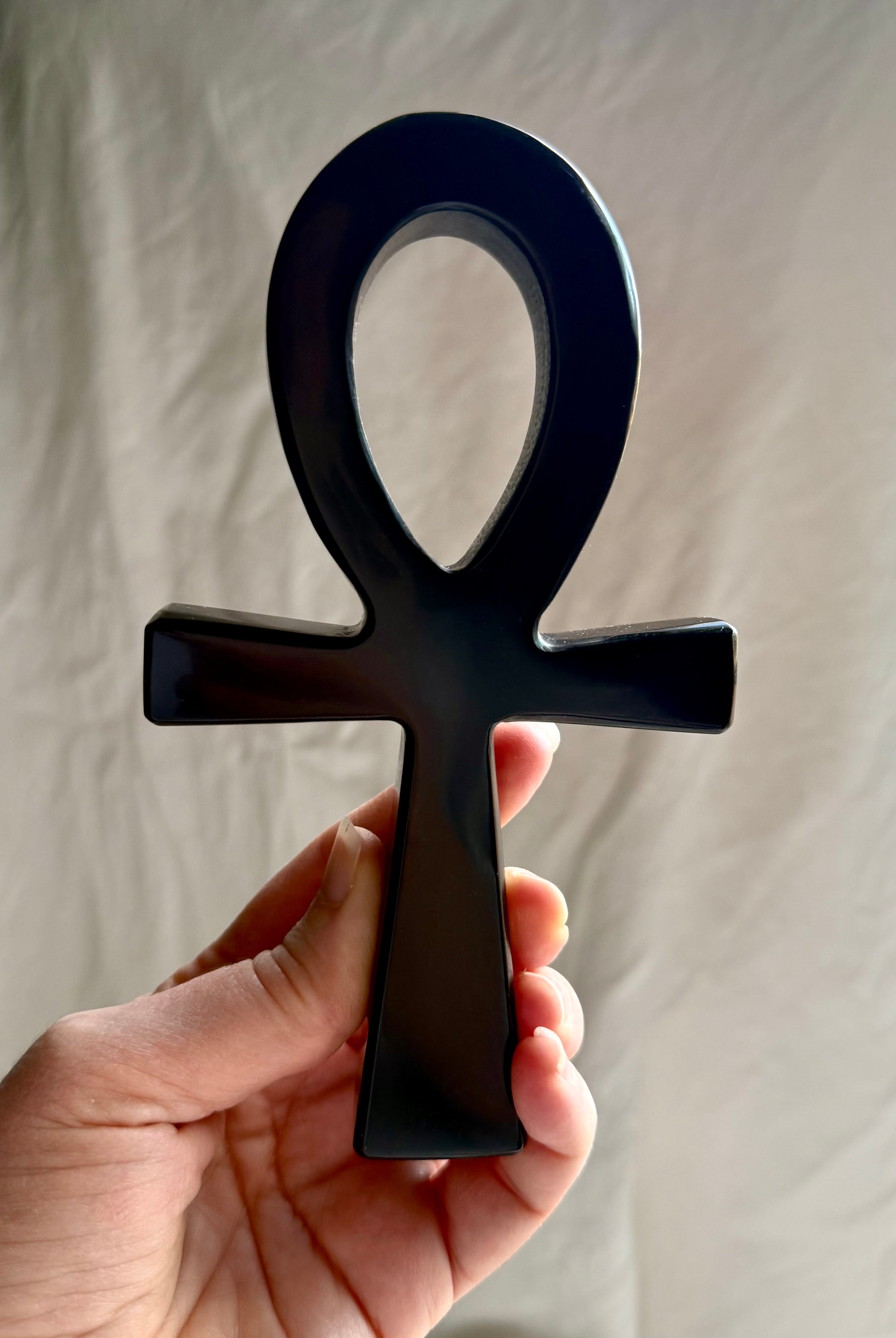 Black obsidian ankh crystal — protective talisman symbolizing life force and divine connection.