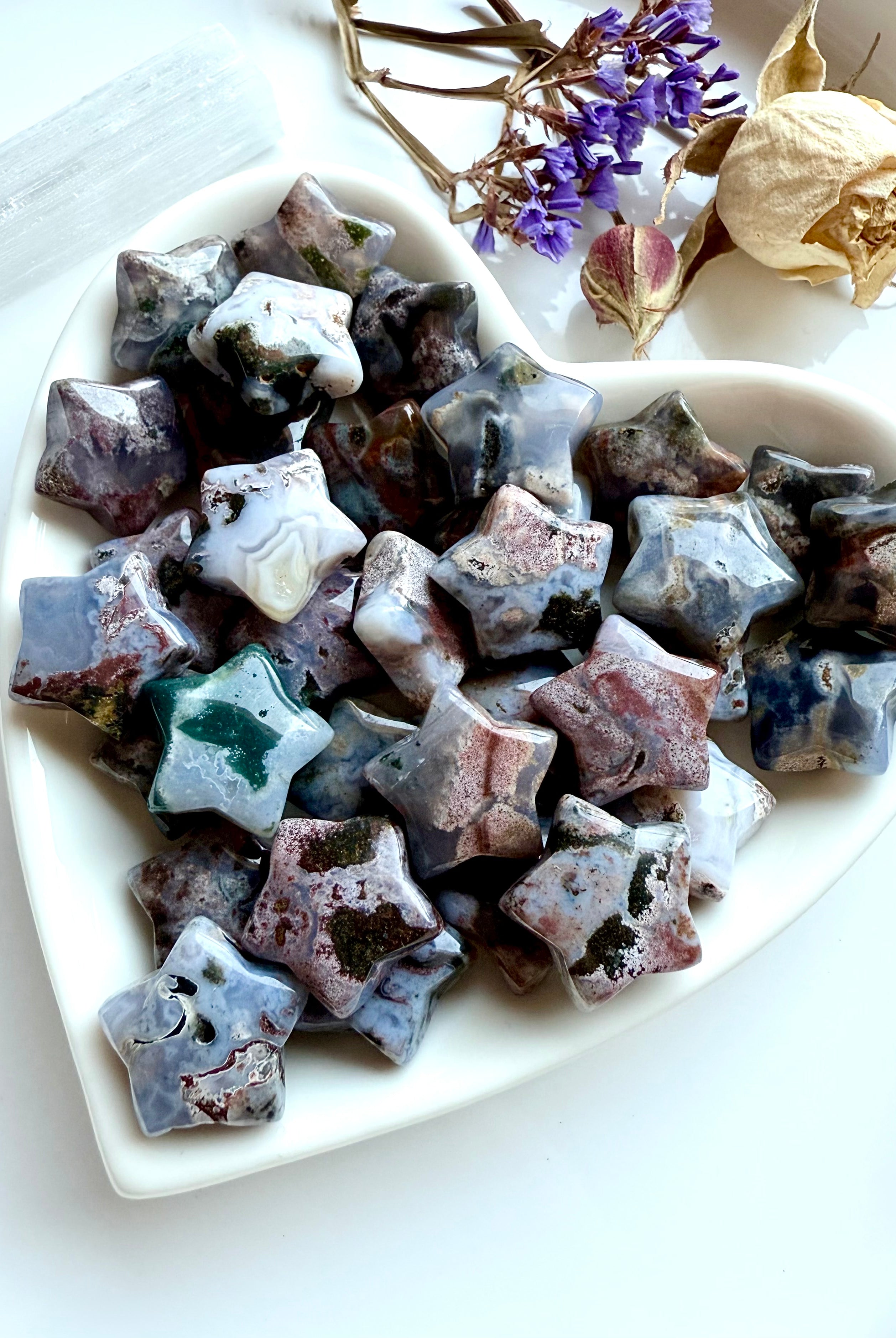 Heart-shaped dish filled with Ocean Jasper stars — crystal carvings for celestial décor, grounding, and heart chakra energy