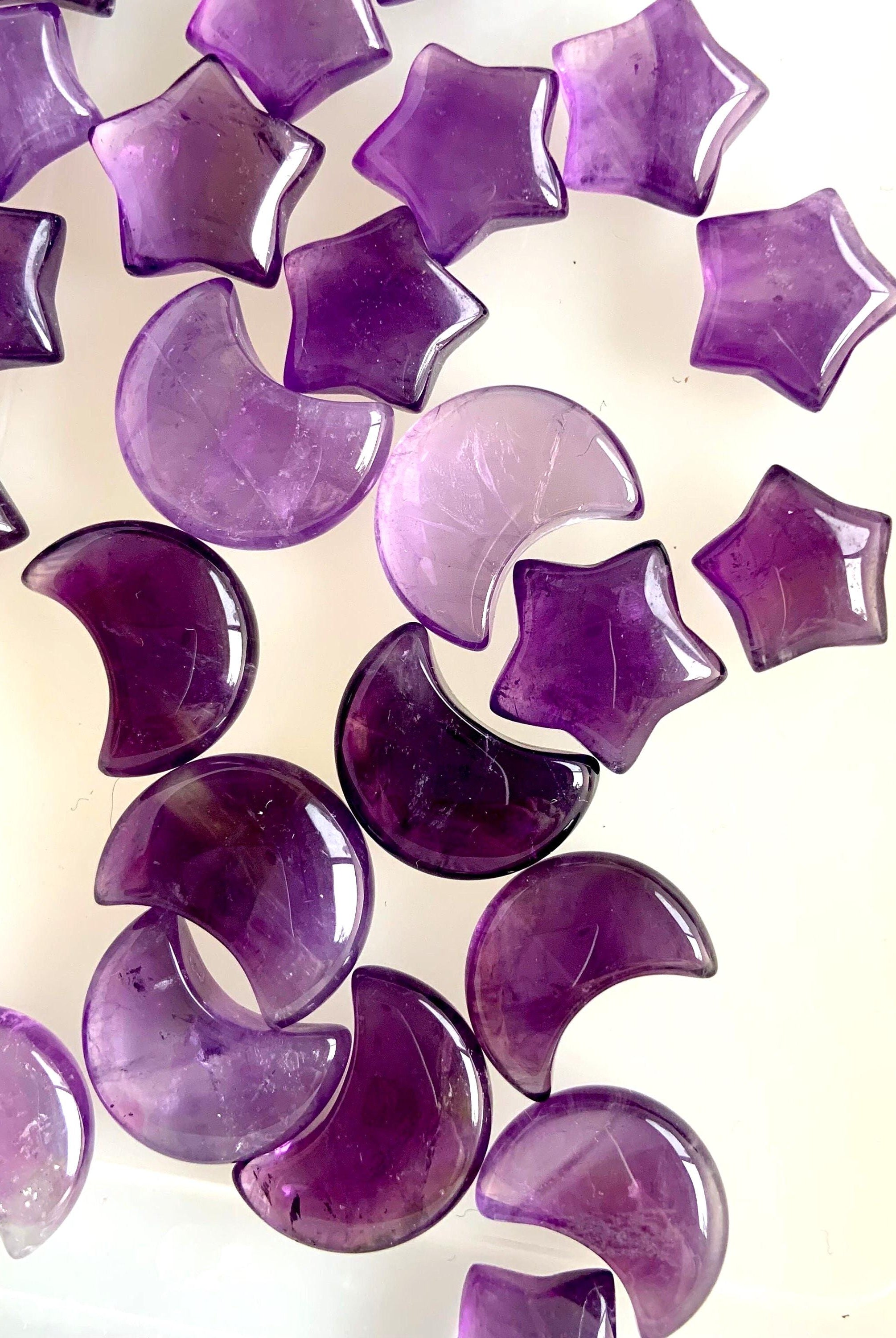 Mini amethyst moon + stars on a translucent background to show the clarity & quality of the crystal