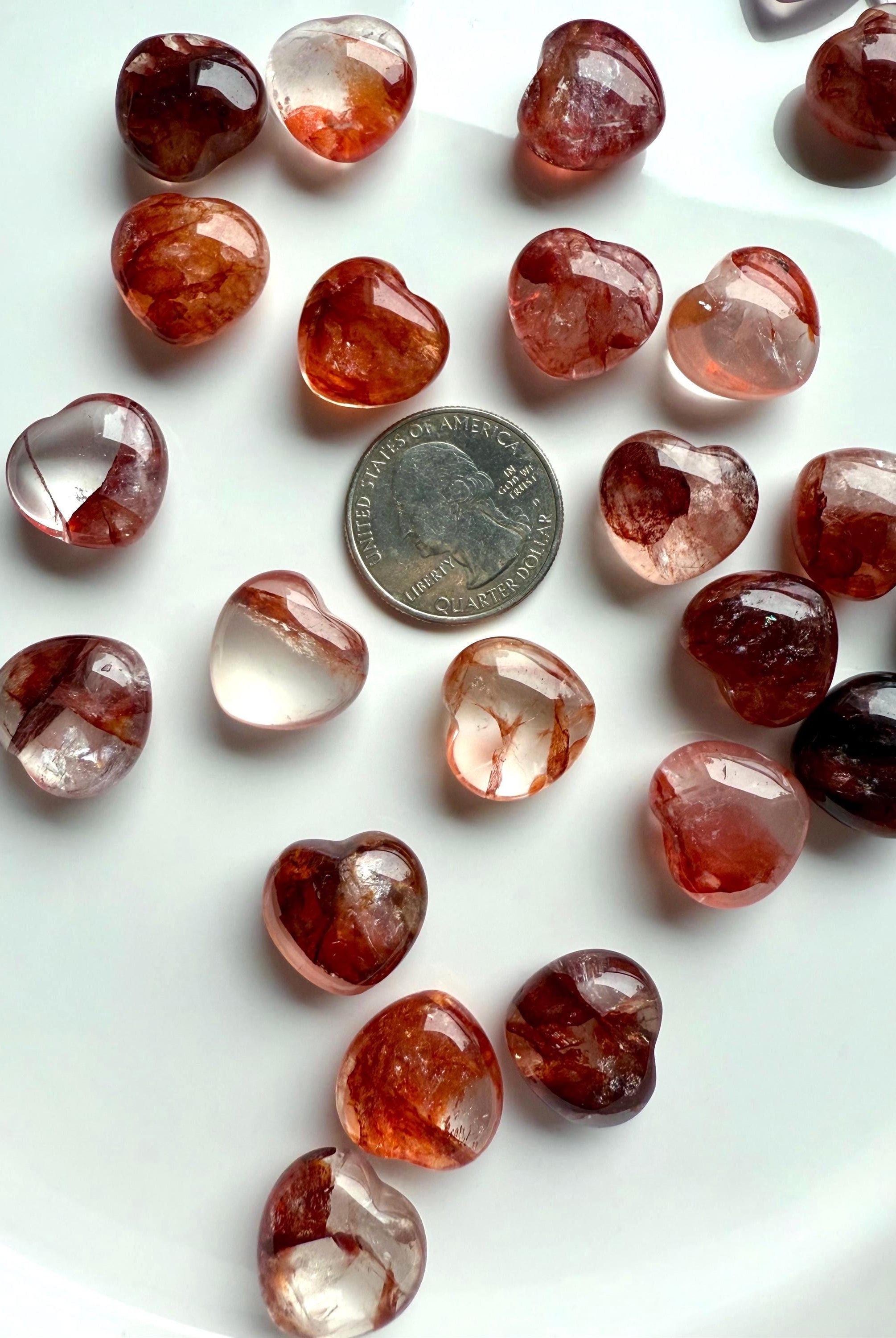 Gemmy, high quality Mini Fire Quartz Crystal Hearts shown with a quarter for scale