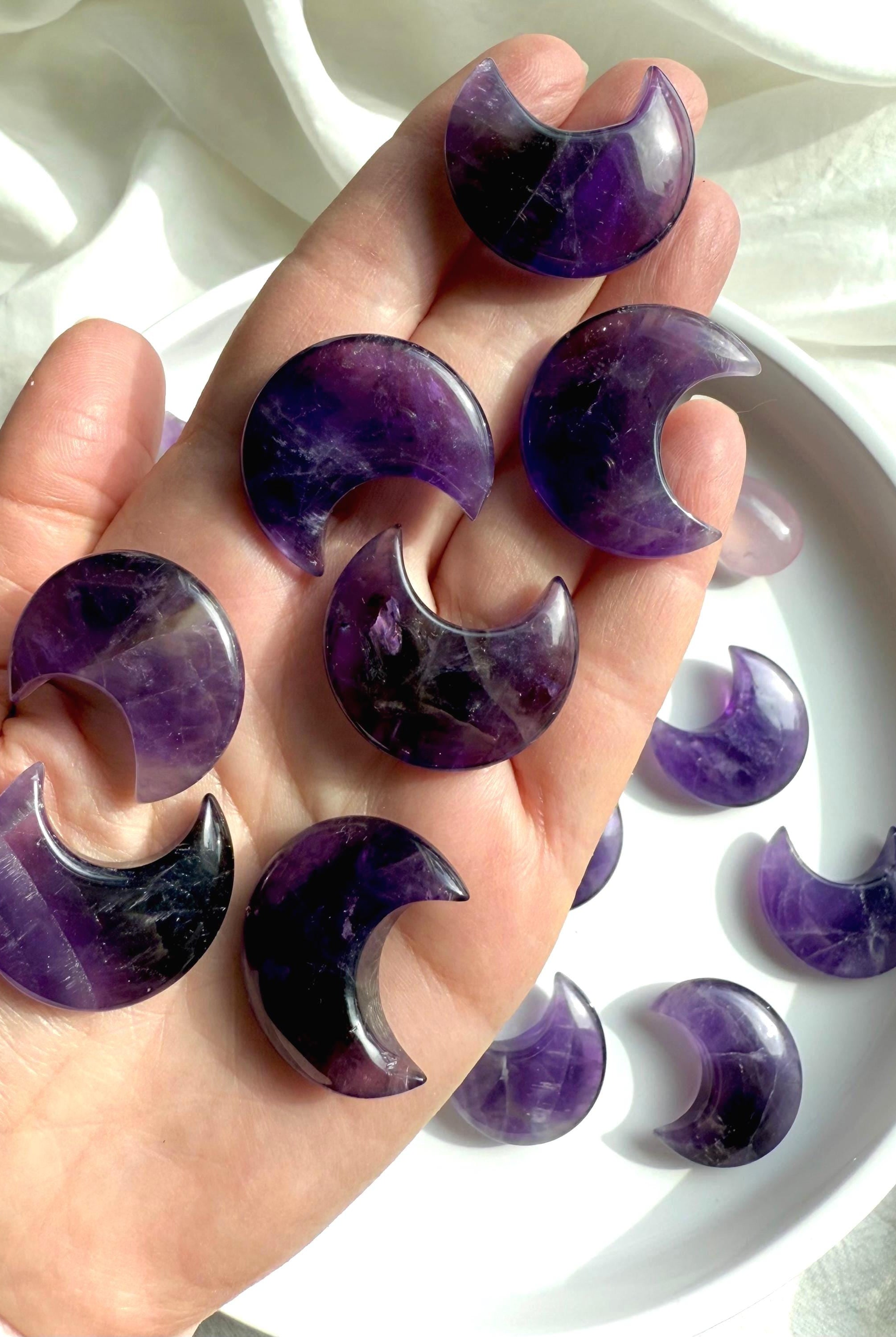 High quality deep purple Dream Amethyst Moons shown on my hand for scale