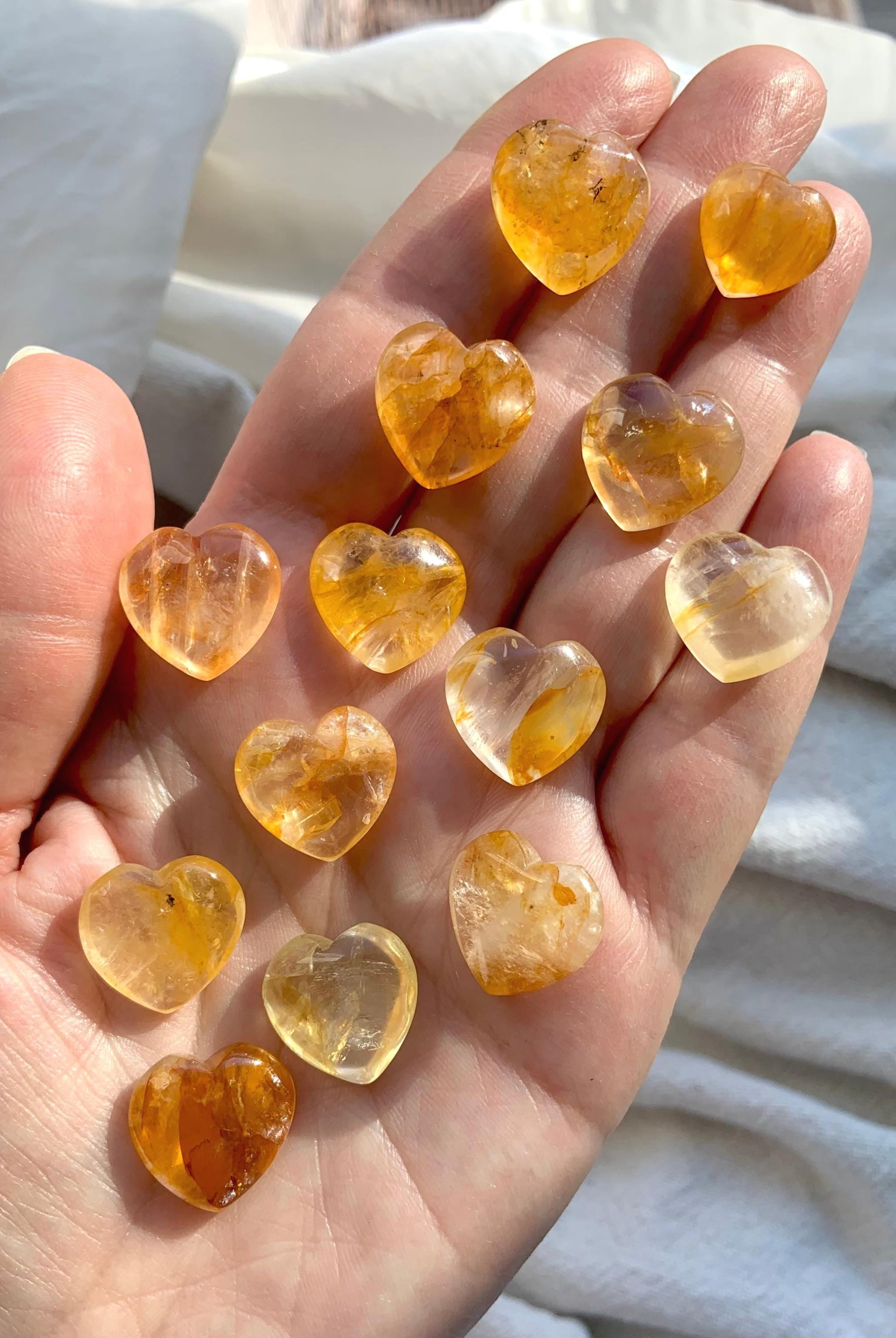 Tiny Golden Healer Crystal Hearts shown on my hand for scale