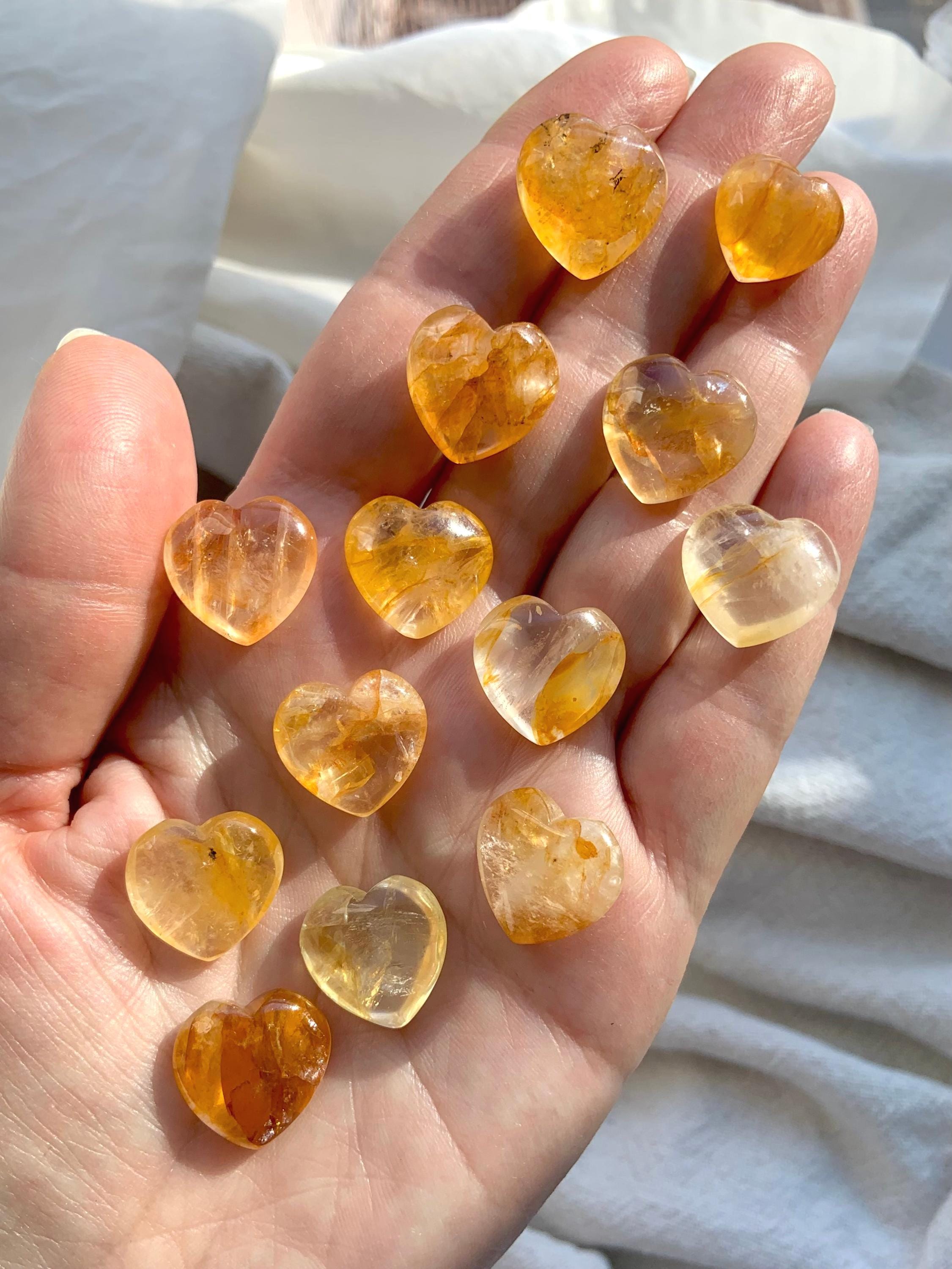 Tiny Golden Healer Crystal Hearts shown on my hand for scale